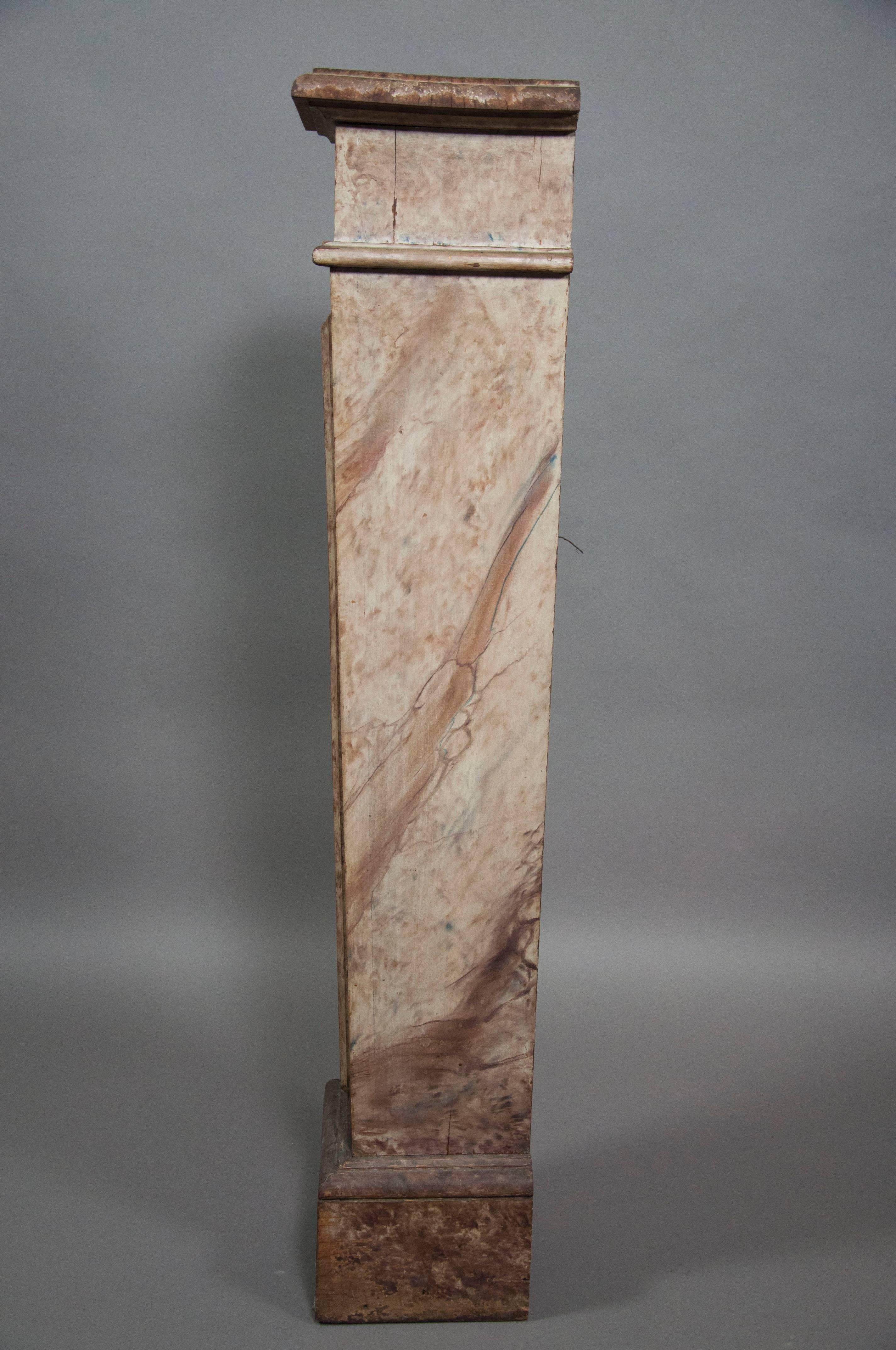 Rectangular top over a panelled tapered midsection on a plinth base.