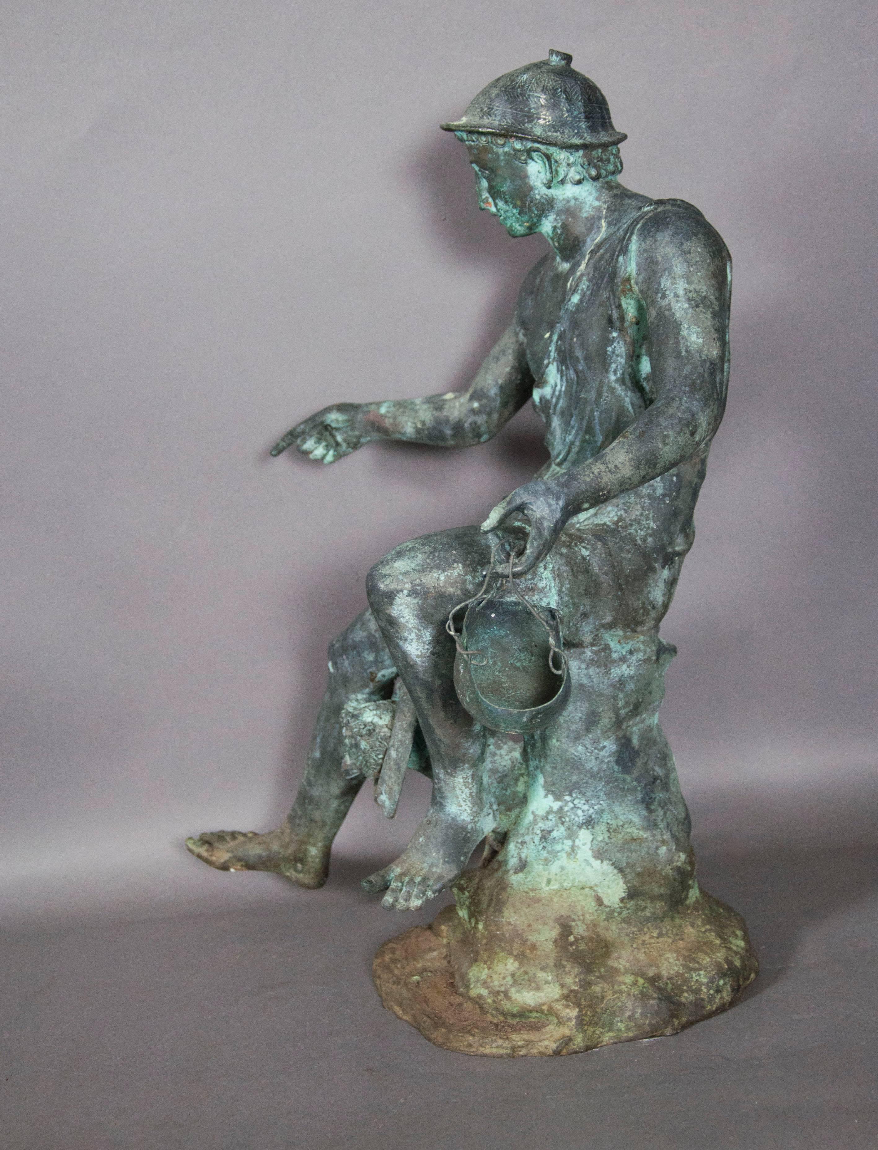 Modeled after the original located at The House of the Small Fountain in Pompeii. Depicting an Etruscan man standing over a figural fountain head with one arm outstretched and the other holding a pail. 