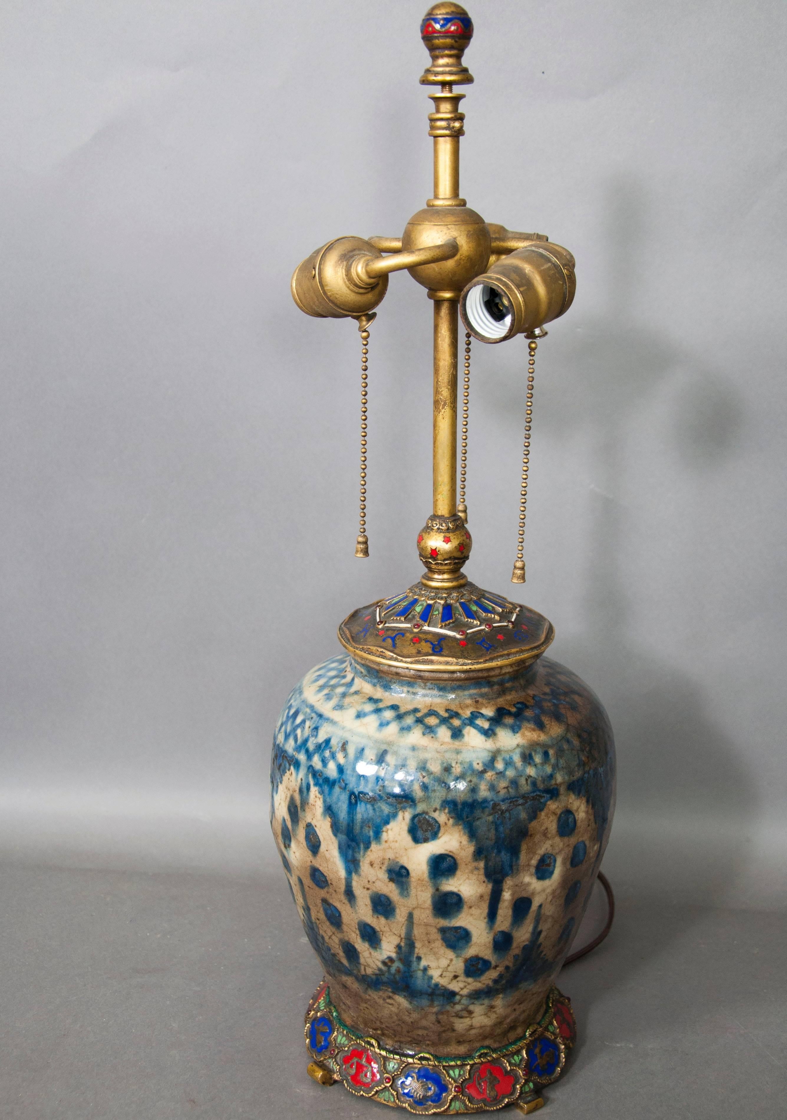 With enamelled ball form finial over three-light sockets, the globular blue and white vase dating from the 18th-19th century with decorated enamel cap and a base with all the figures of the zodiac.