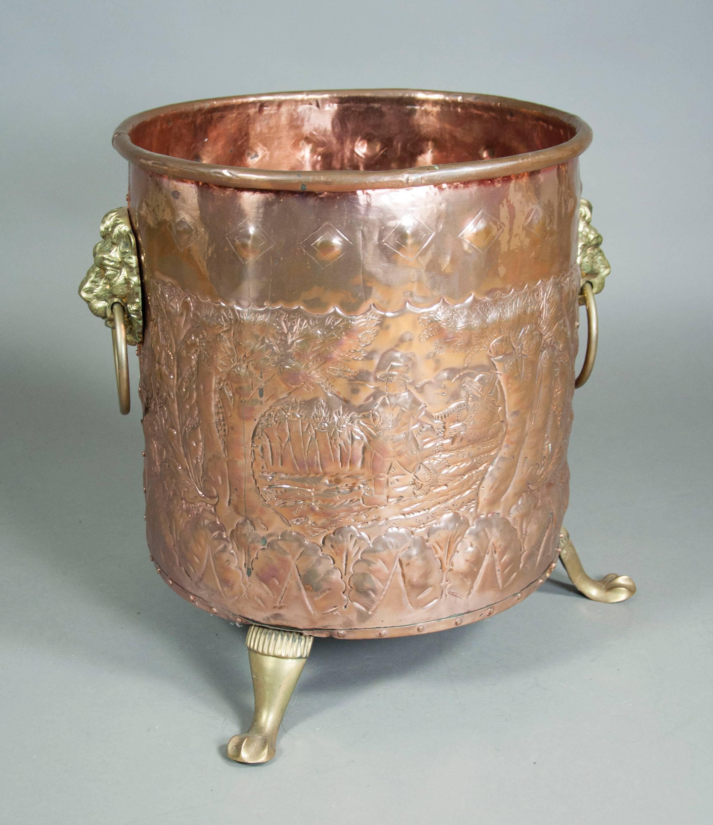 Hand hammered decorated copper body with mounted brass lions heads and brass legs