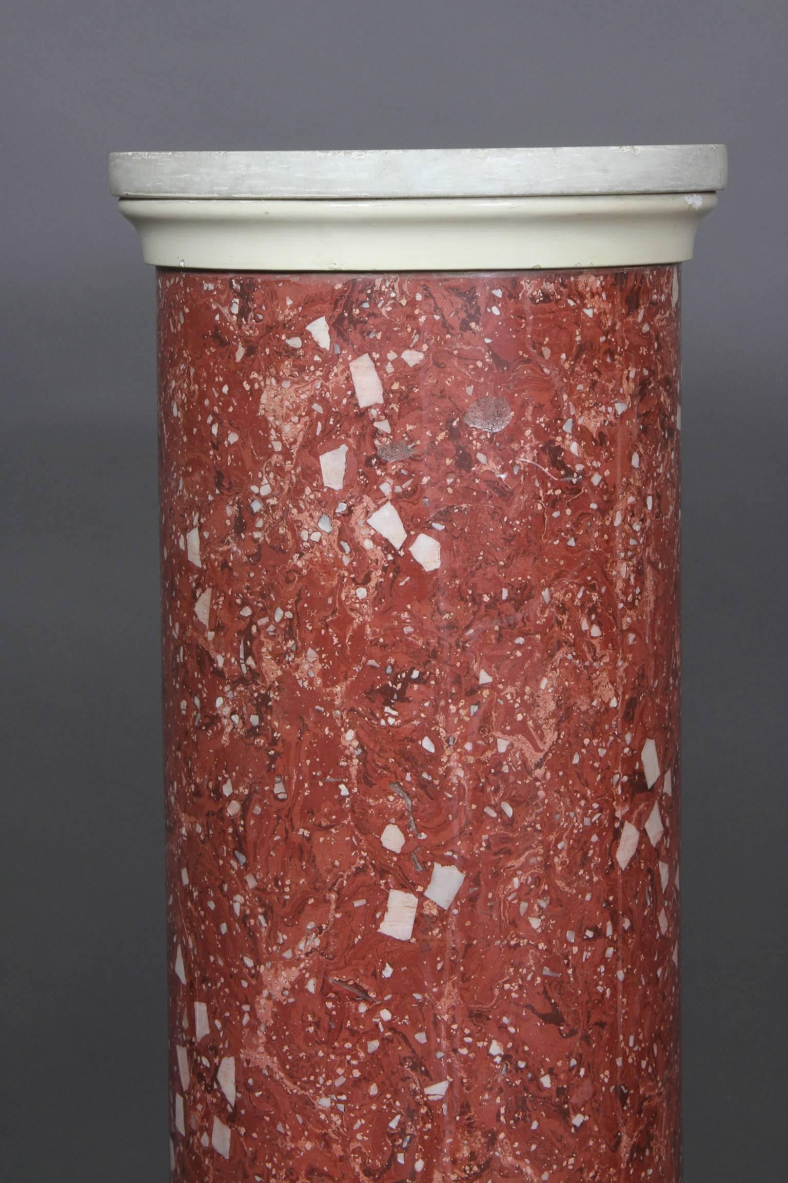 With carrara marble top and wonderful color red faux marble column on a painted wood base.