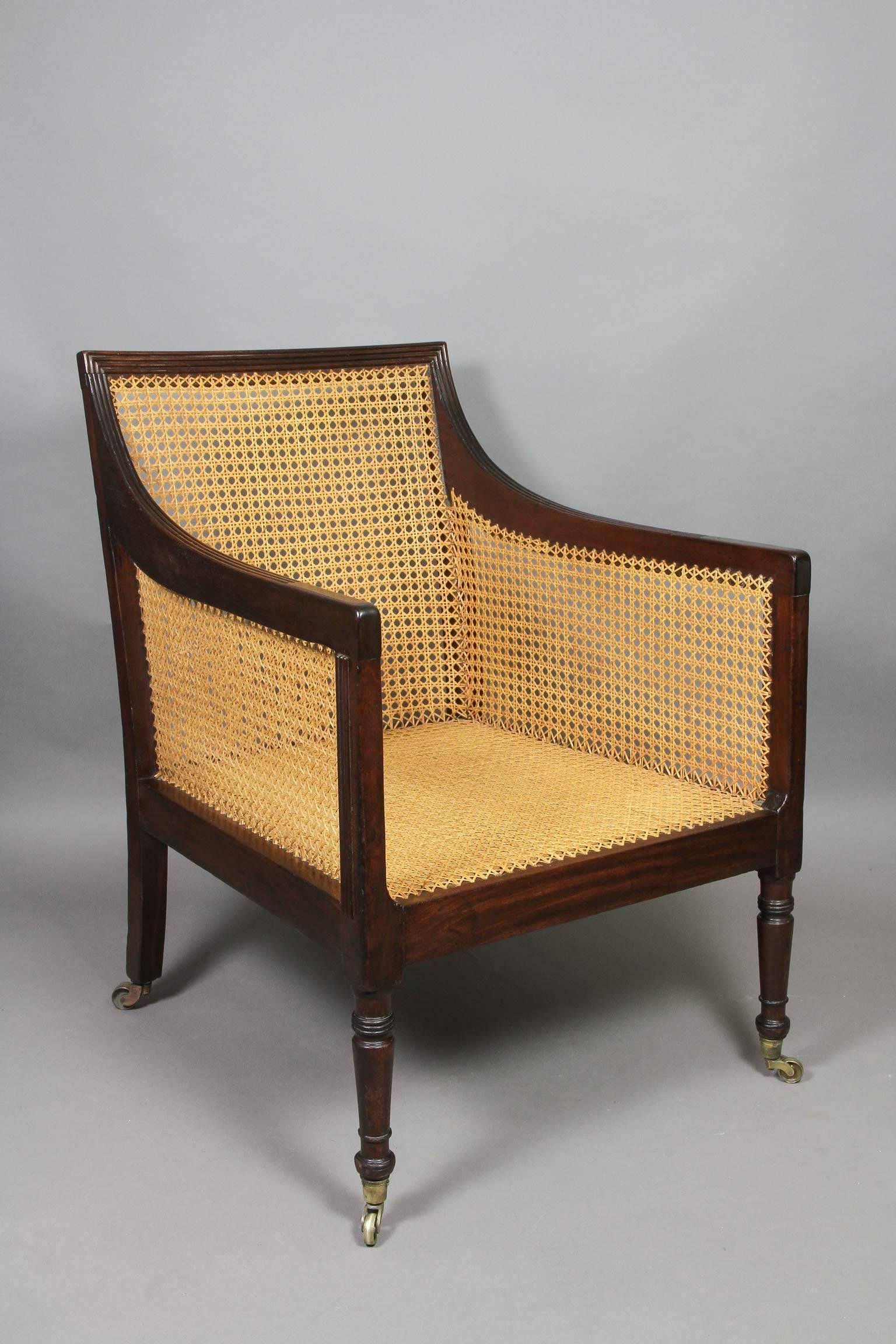 Reeded frame with caned seat sides and back raised on turned tapered legs , casters