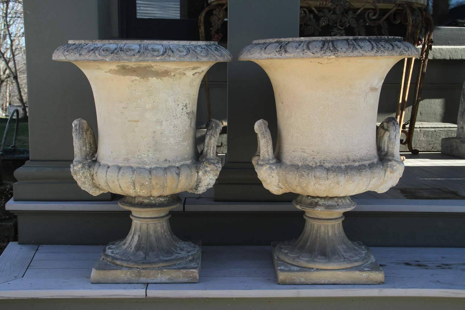 Each of campana form , with gadrooned edge , the sides fitted with handles , fluted socle on a square base each stamped J. Stiff & Sons. James Stiff was an English potter born in Suffolk who worked at Eleanor Coades Manufactory , Lambeth , South