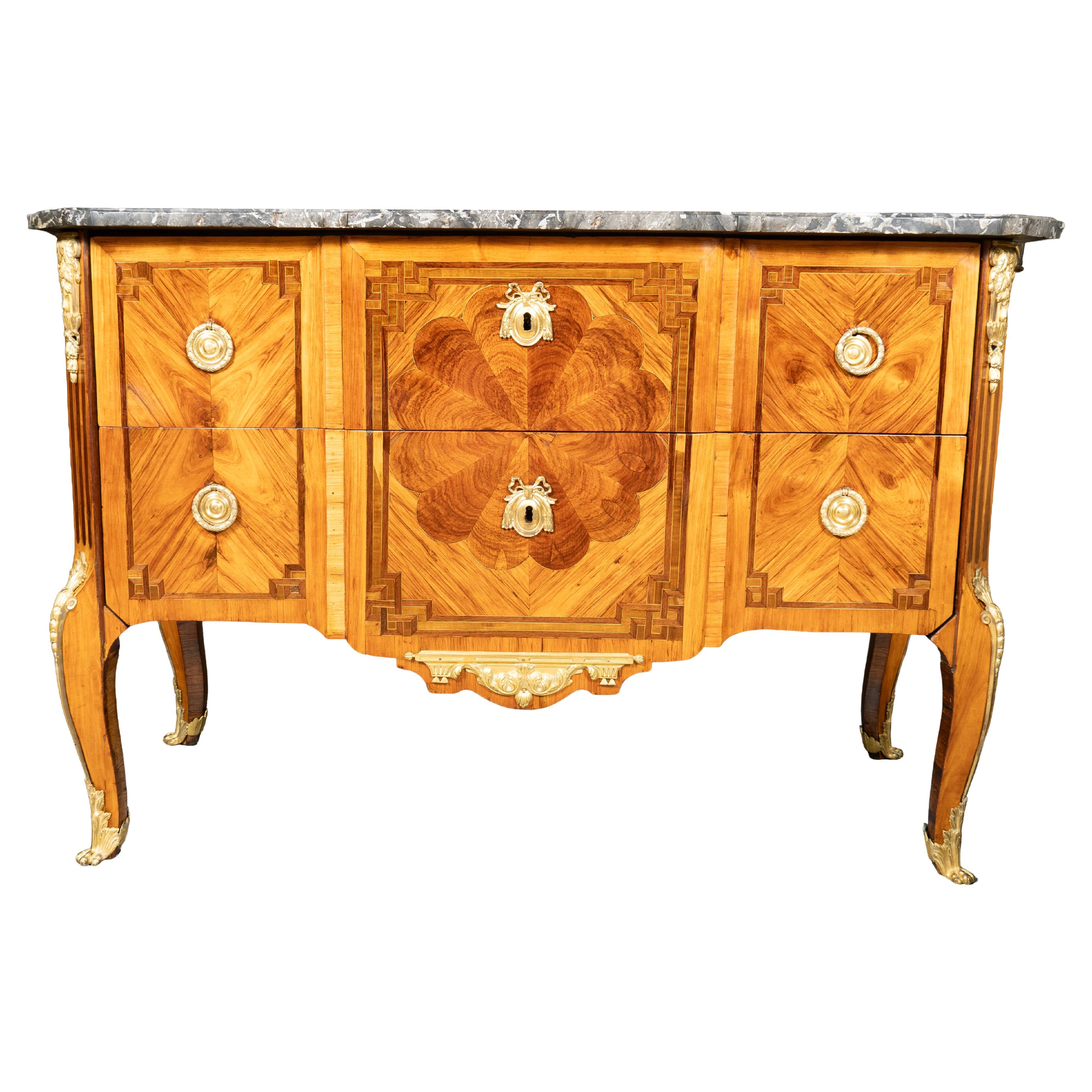Grey and white original marble top and conforming case section with two drawers in traverse and having gilt bronze ring handles. Central circular inlaid panel typical of the maker. Ormolu mount on center of base. Slight cabriole legs and gilt bronze
