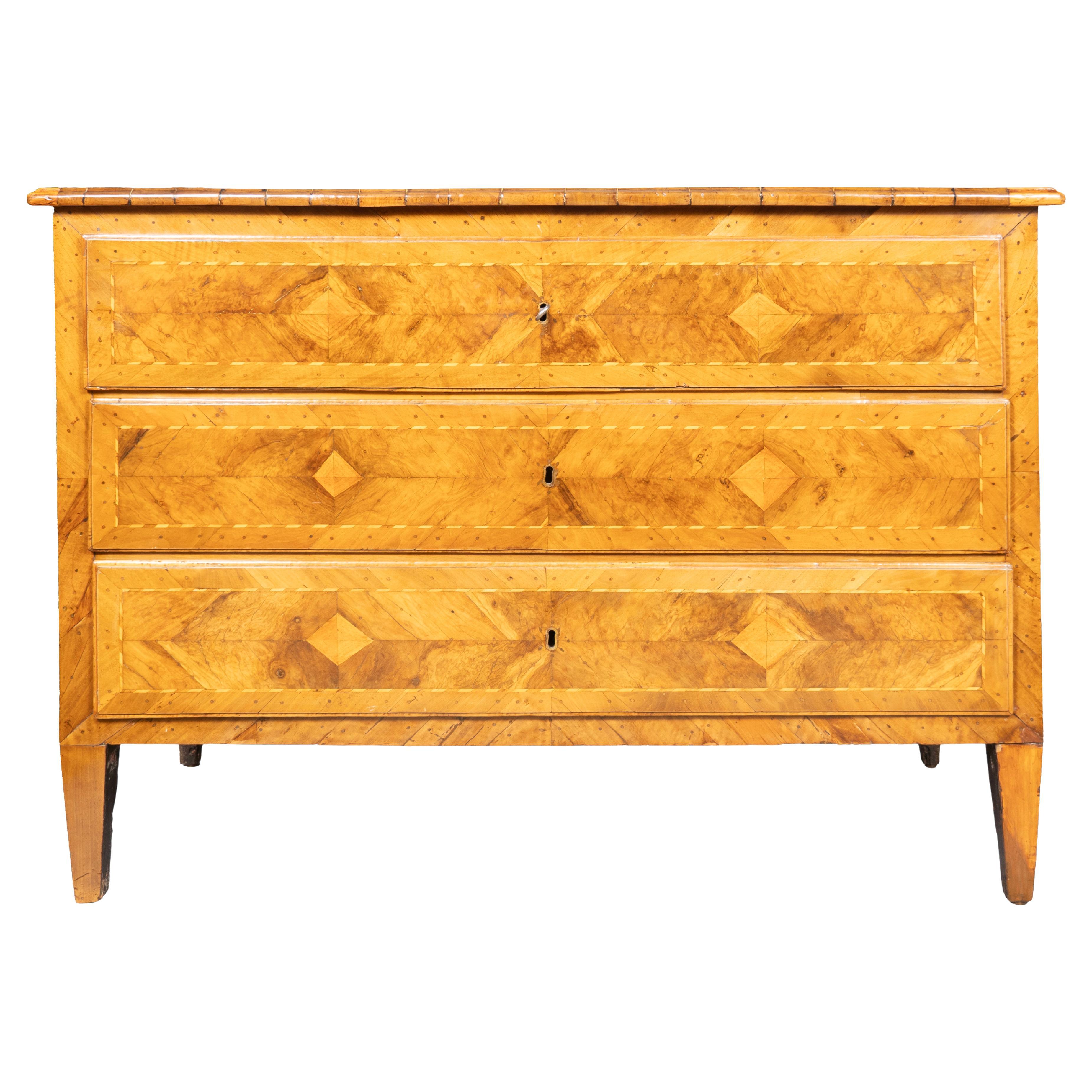 From a Miles Redd install. Rectangular top with central oval inlay. Three drawers all with keys. Square tapered legs.