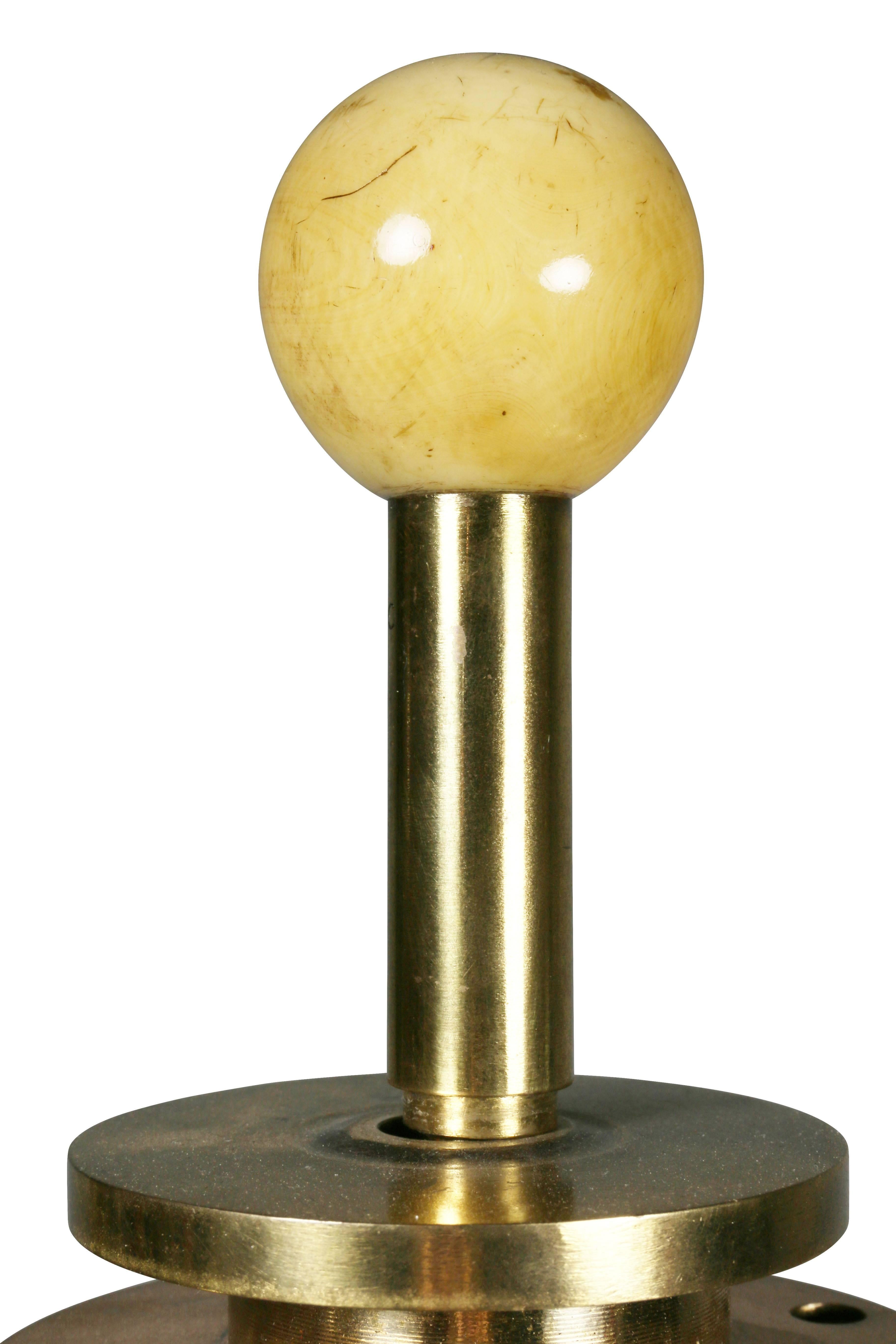 With ball finial over two lights and two pull chains cylindrical support and weighted stepped circular base.