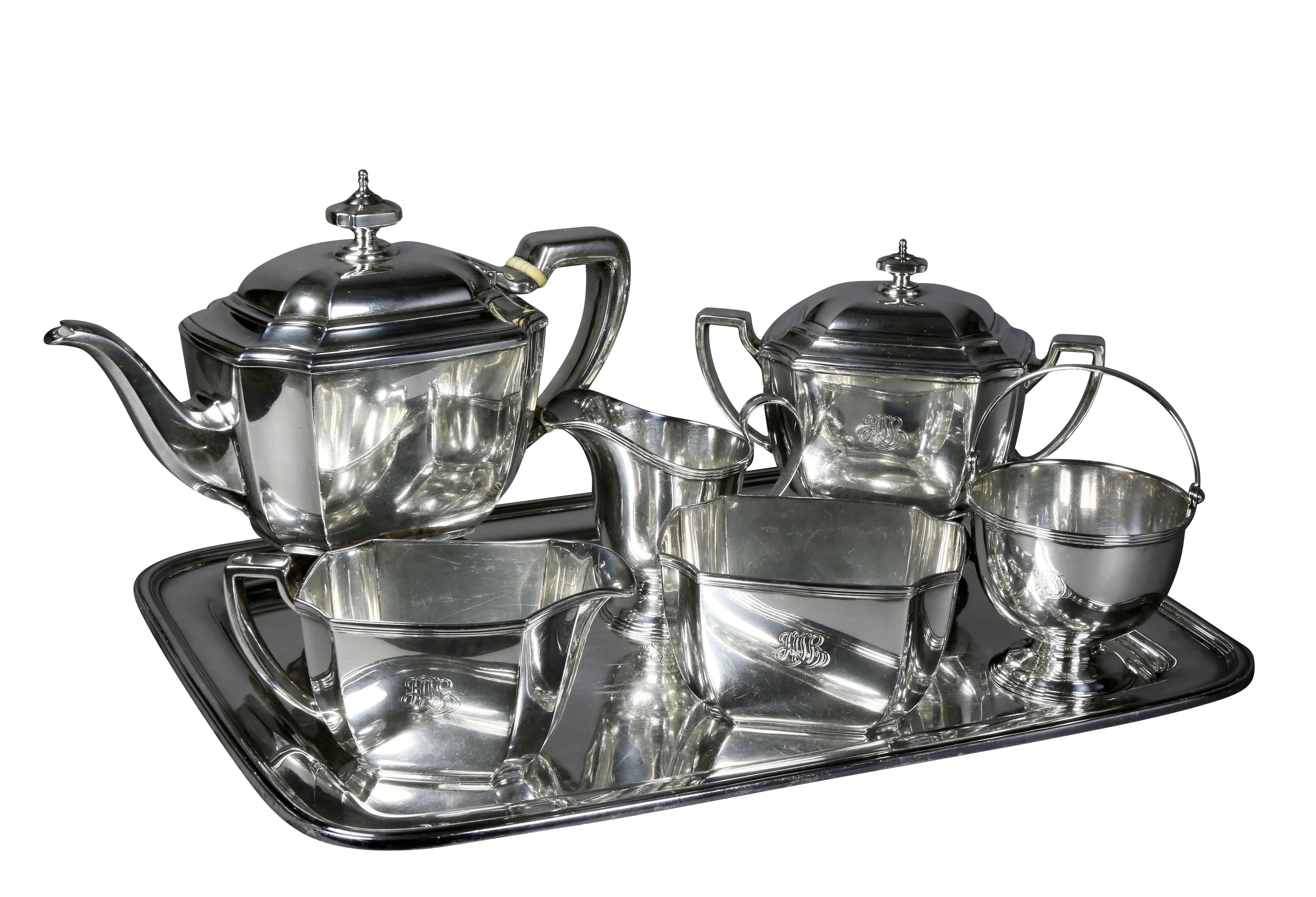 With a silver plated tray, comprising a teapot, waste bowl, covered sugar, milk jug, creamer and an open sugar basket. Approximately 63 troy ounces. With Tiffany monogram. All marked Tiffany and Co Sterling.