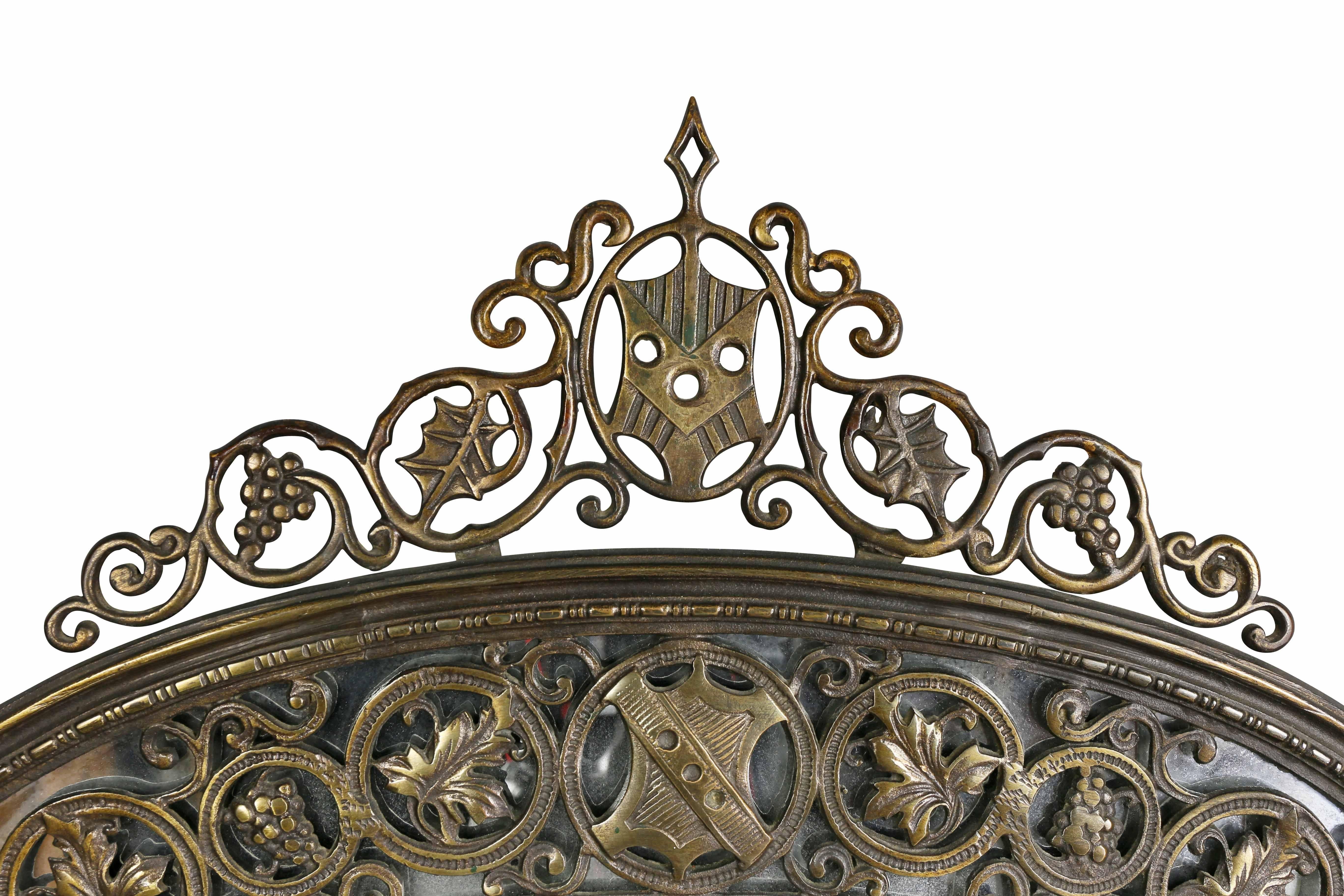 In the Renaissance style with outer mirror with scrolling decorative motifs, arched crest with central shield.