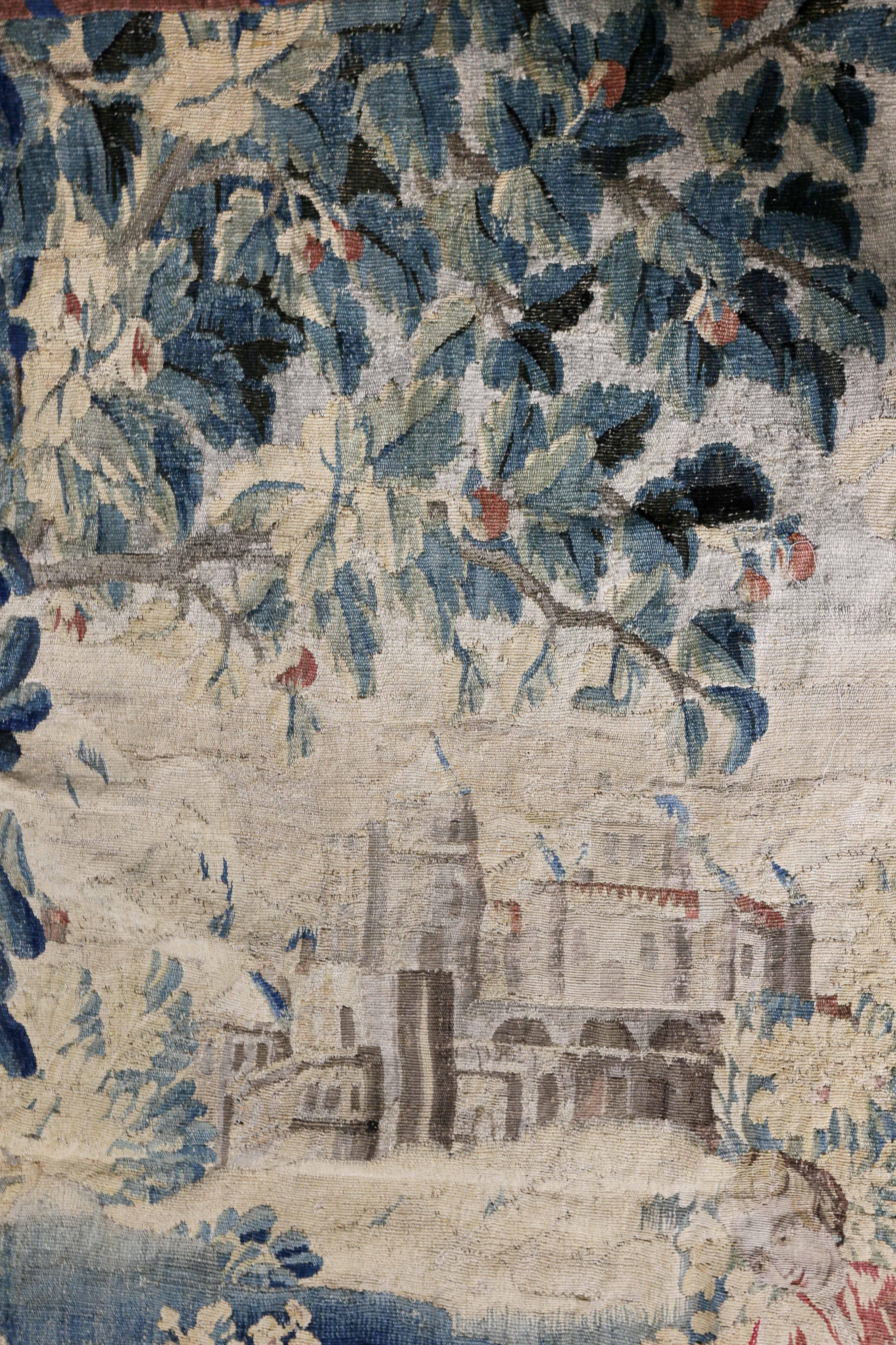With ribbon border and scene of a couple with sheep in the foreground and castle in the background.