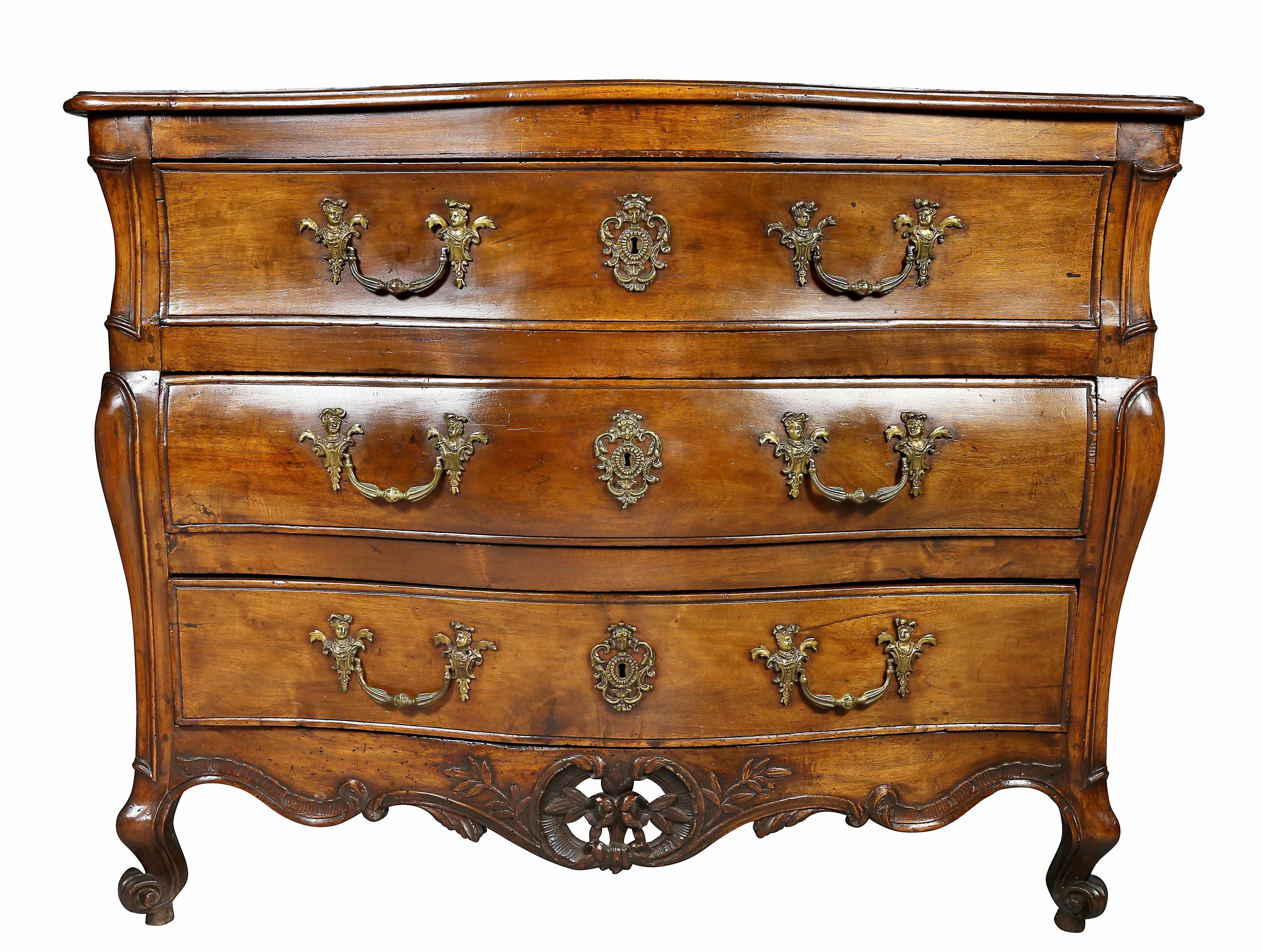 With serpentine top over three drawers with original handles and a carved floral pierced apron raised on carved scrolled feet. Provenance; Fogg Estate, Chestnut Hill, Mass.