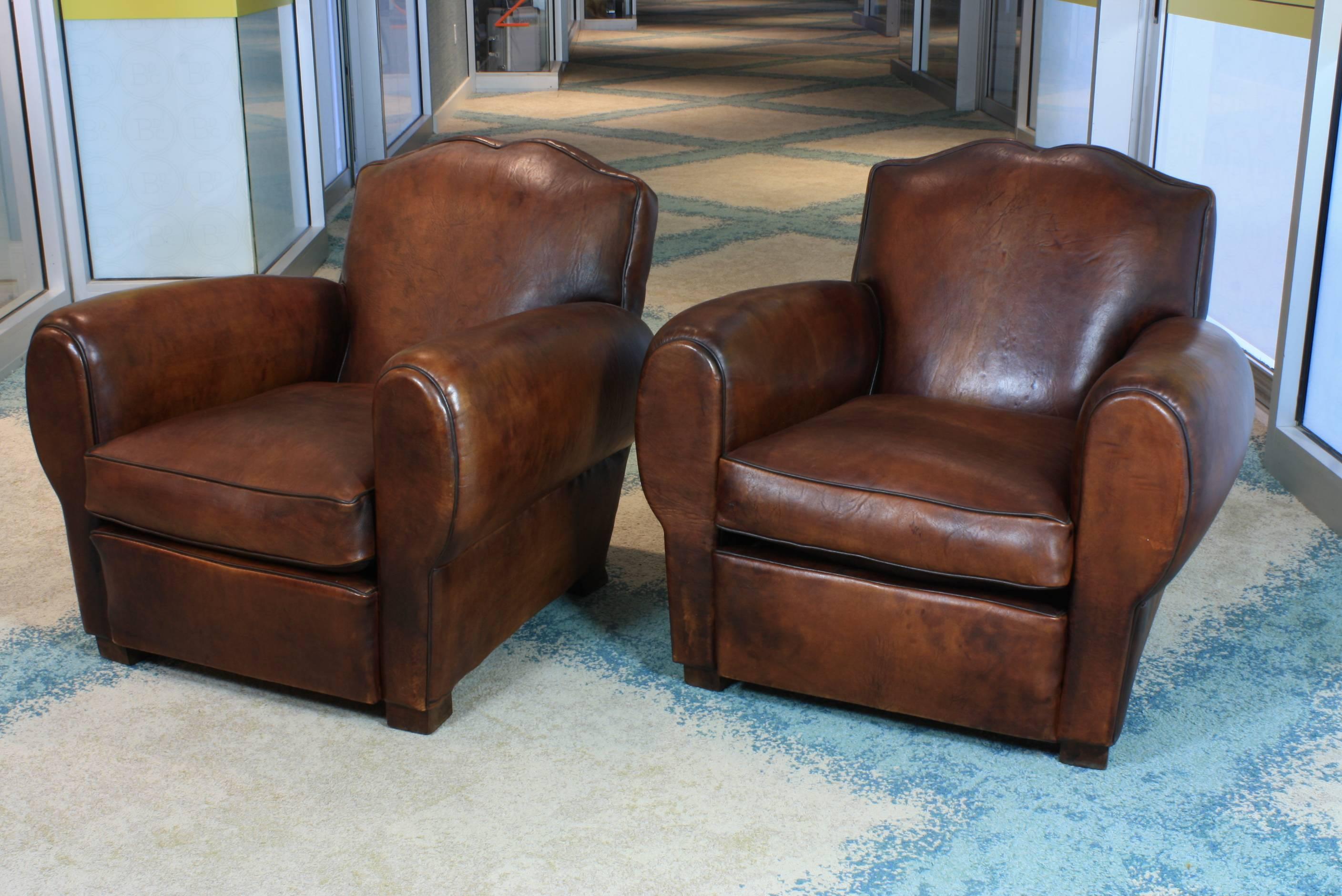 A nice compact pair of French leather club chairs, completely reconditioned and restored, with separate seat cushions (reverse side is suede.) Chairs have Classic 