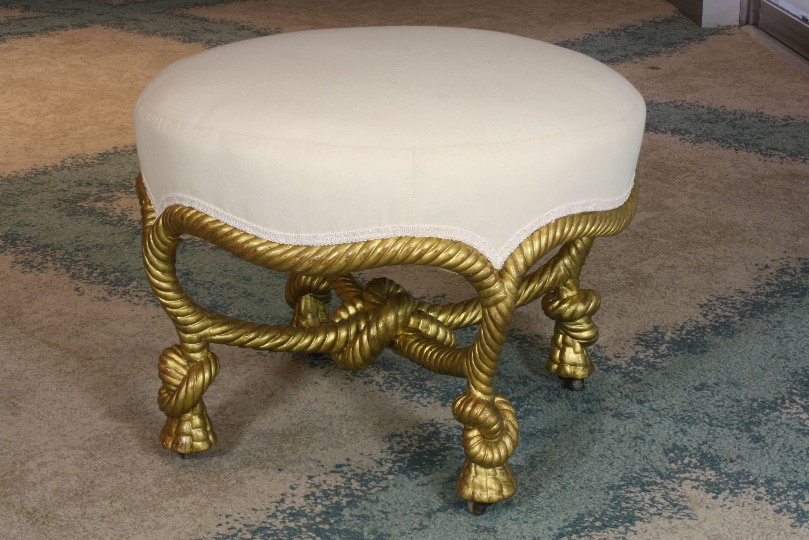 A lovely French, Napoleon III period French giltwood knotted rope tabouret or ottoman with bone casters in the manner of A.M.E. Fournier (circa 1860). This piece has been carefully restored, with the springs being restrung and restuffed, and covered