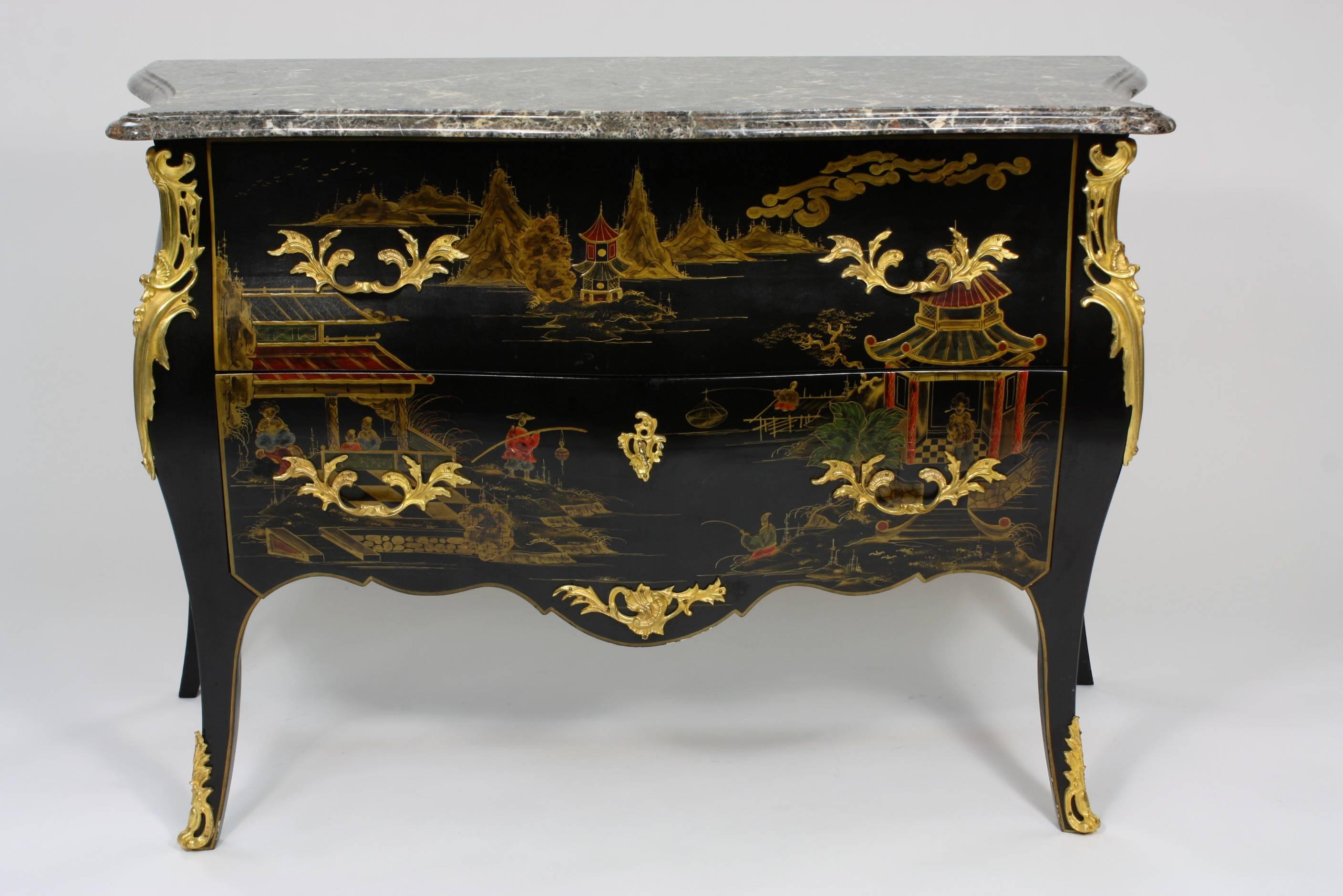 A highly-decorative and very good quality French commode, in the Louis XV style with lacquered Chinoiserie designs, well-cast gilt-bronze mounts, two drawers with working lock and key, and variegated grey and white marble top.  