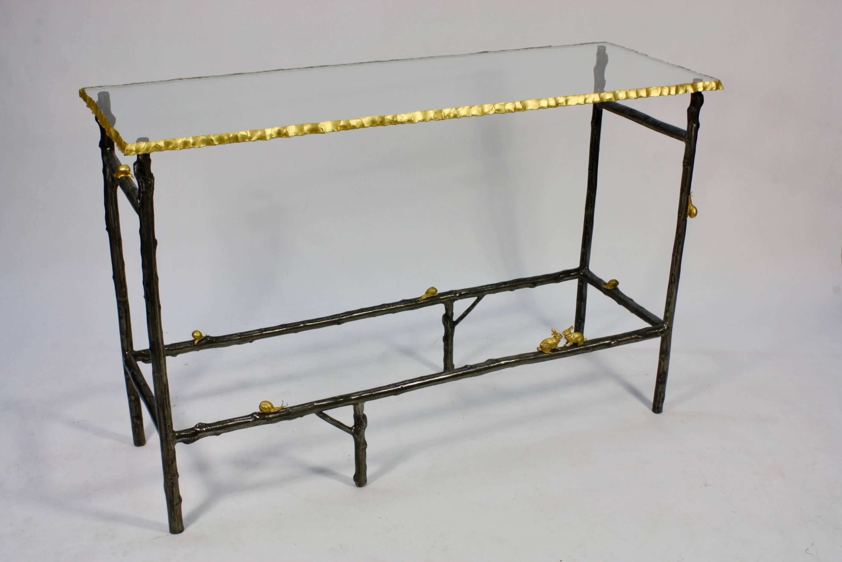 French console table custom made of patinated iron in the form of twigs, with gilt bronze snails and rabbits. The thick glass top (¾