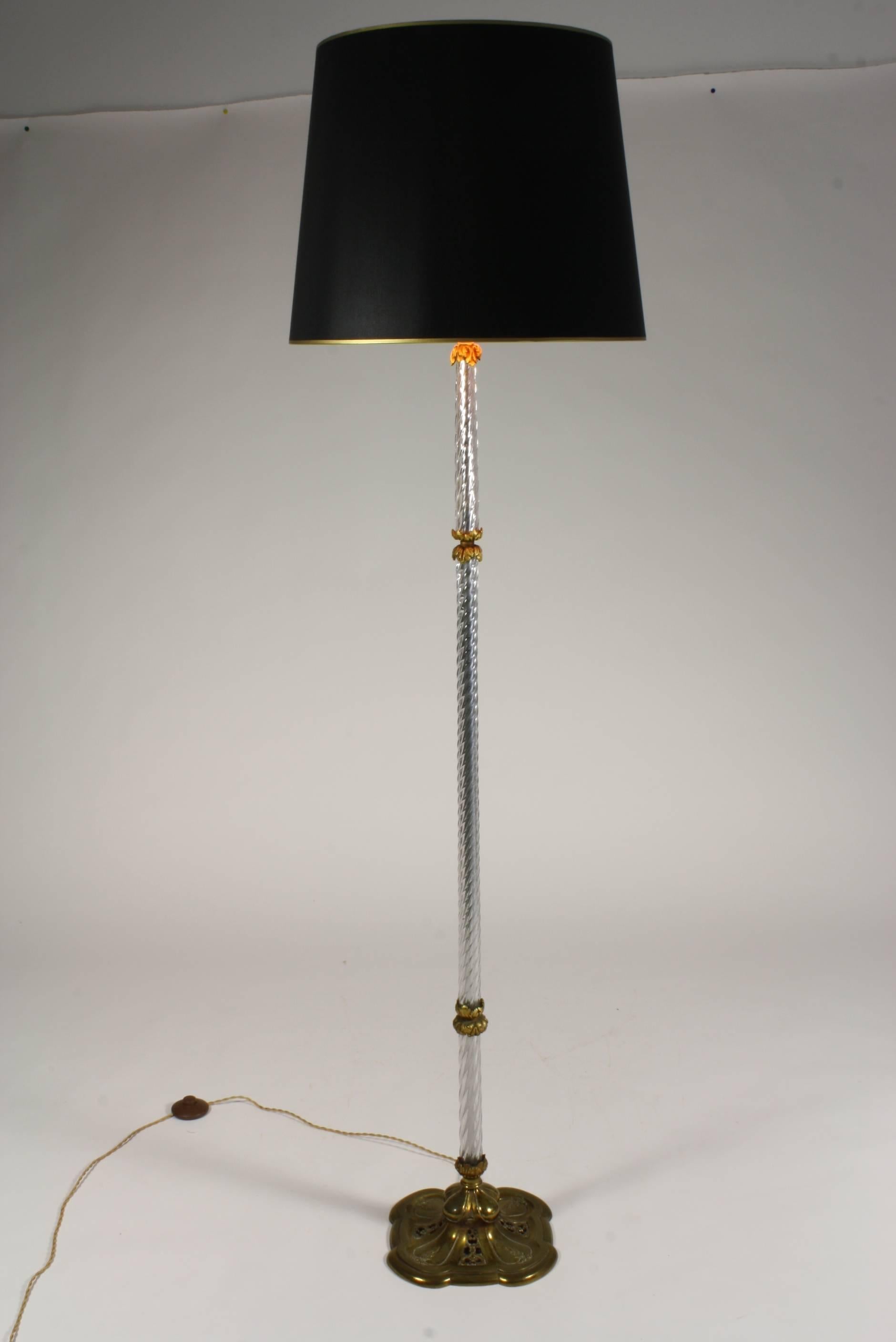 French twisted glass column floor lamp with bronze acanthus leaf mounts and decorative pierced bronze base.  New shade in black silk over gold paper interior with gold trim.  The lamp base is 10.75