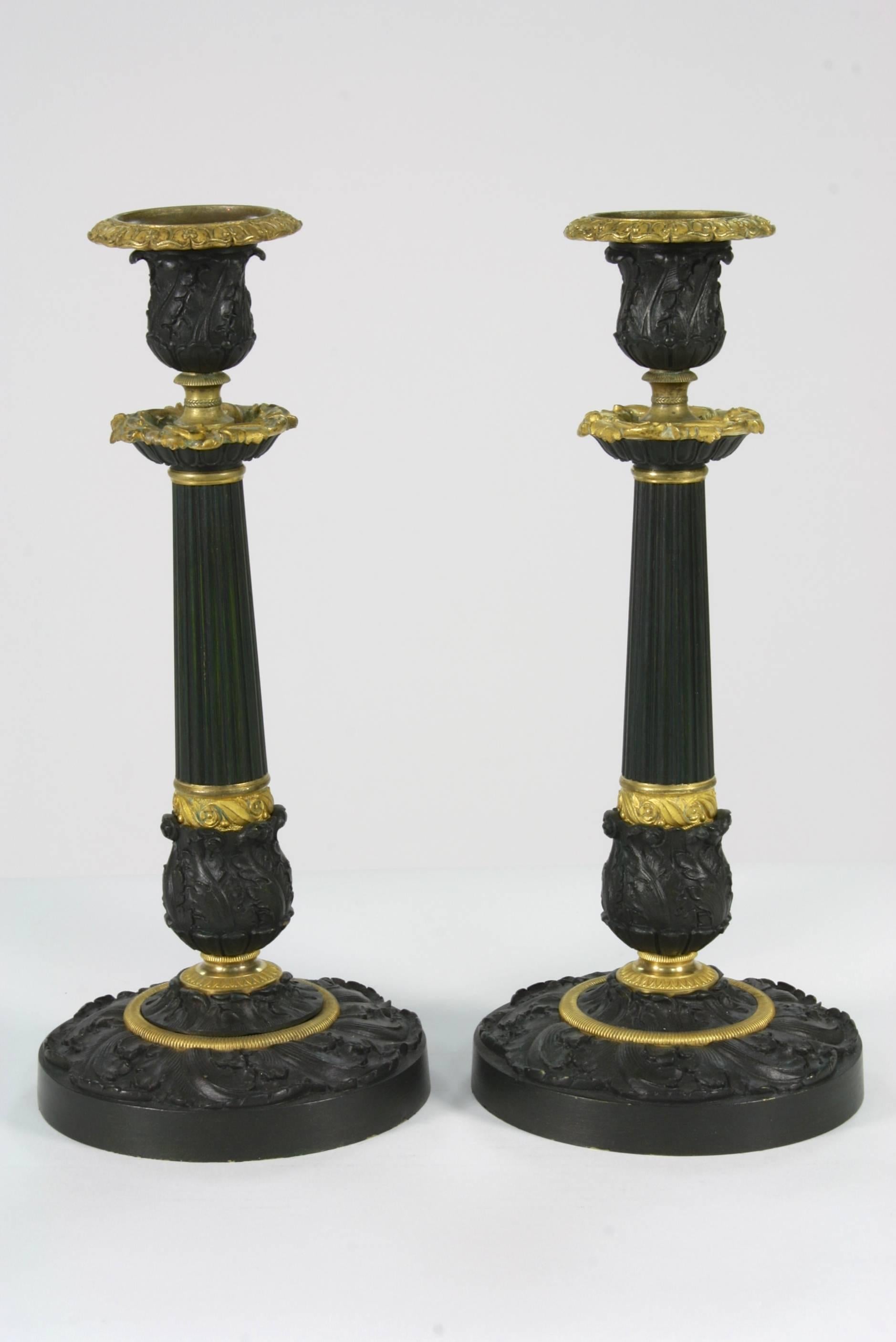 Pair of handsome 19th century French gilt bronze and patinated bronze candlesticks in the Restoration style. Could be electrified and made into table lamps.