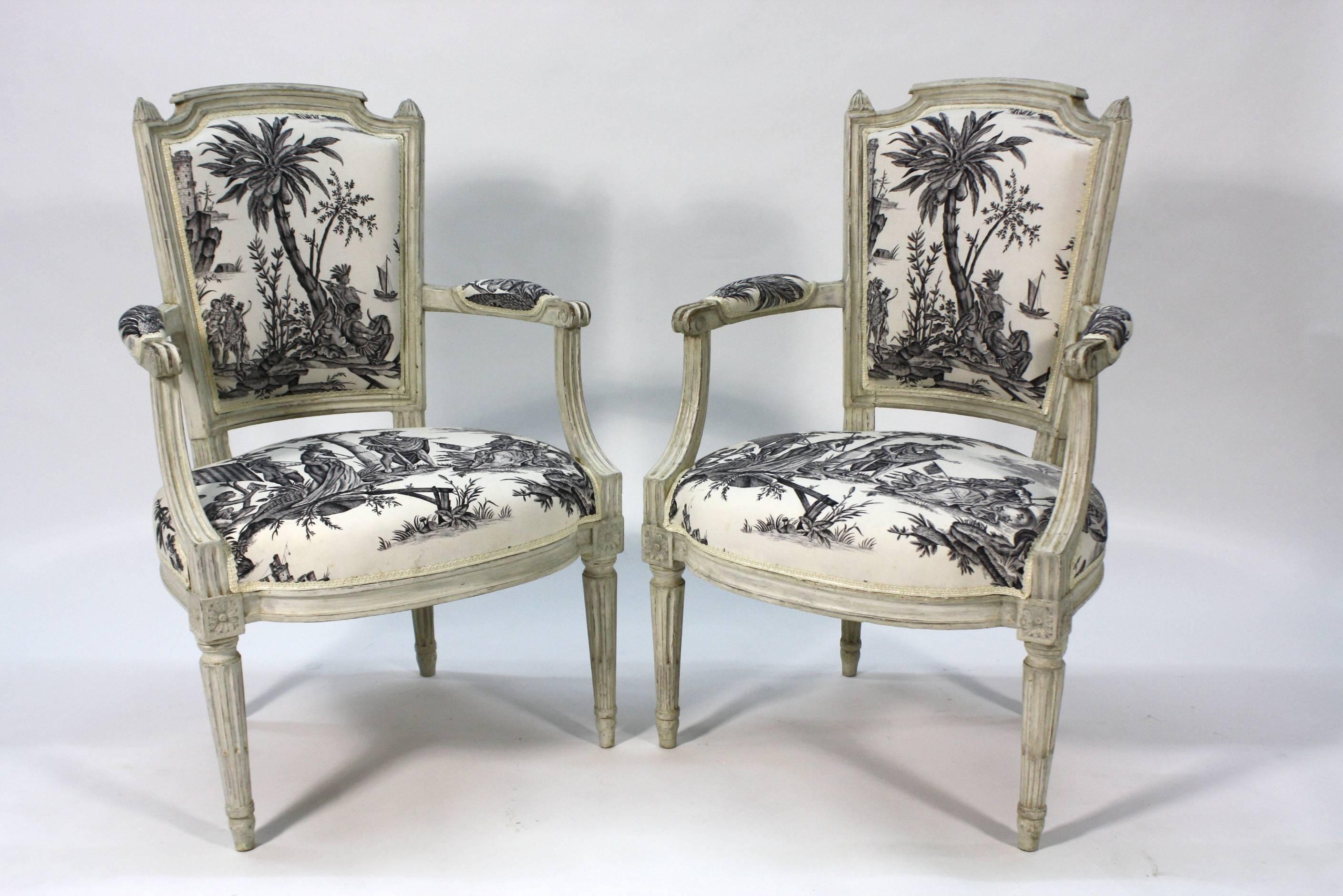 A stunning pair of French Louis XVI style painted armchairs or fauteuils with 