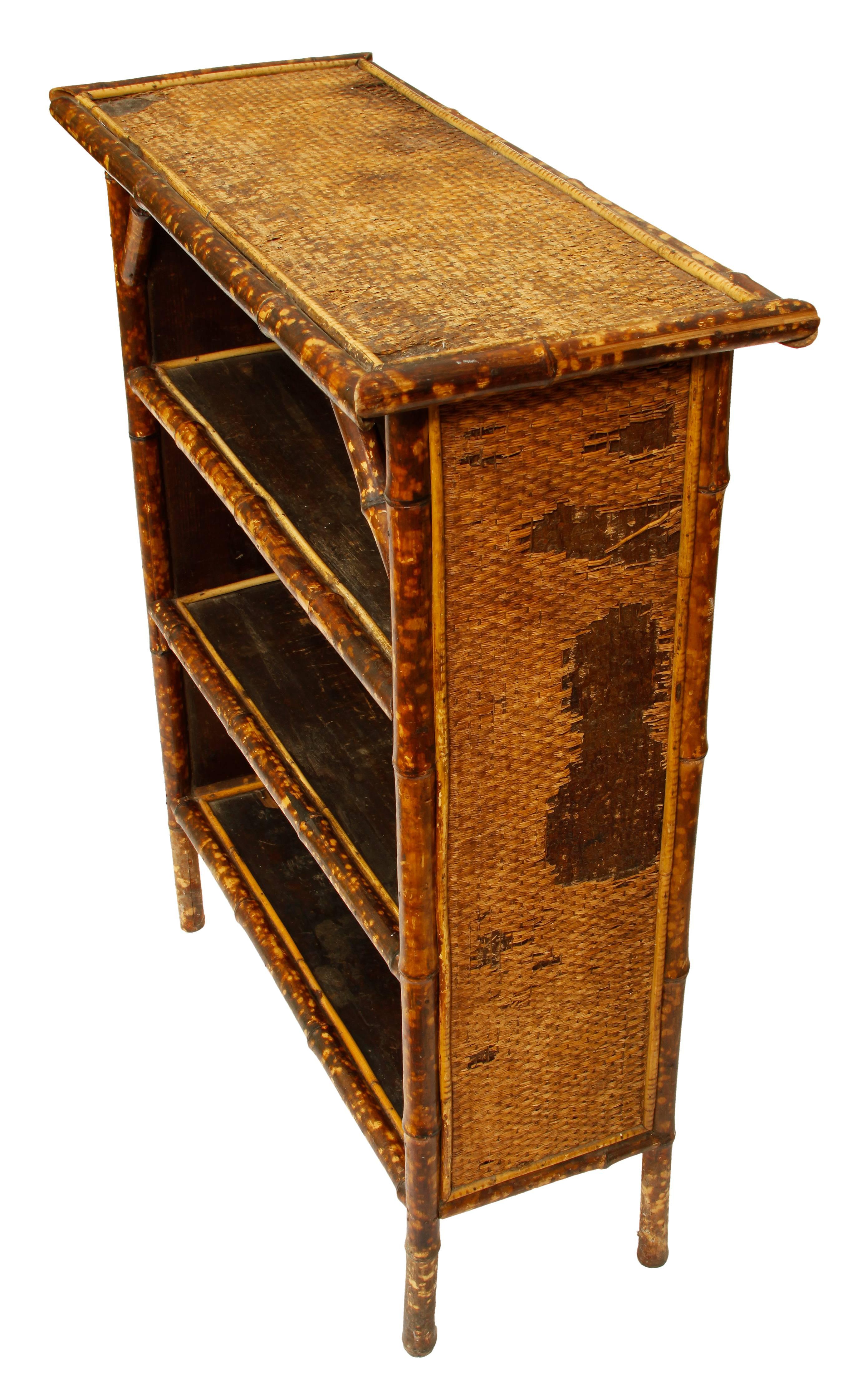 A small charming piece in bamboo with original grasscloth top, this is a perfect spot for books or accessories.