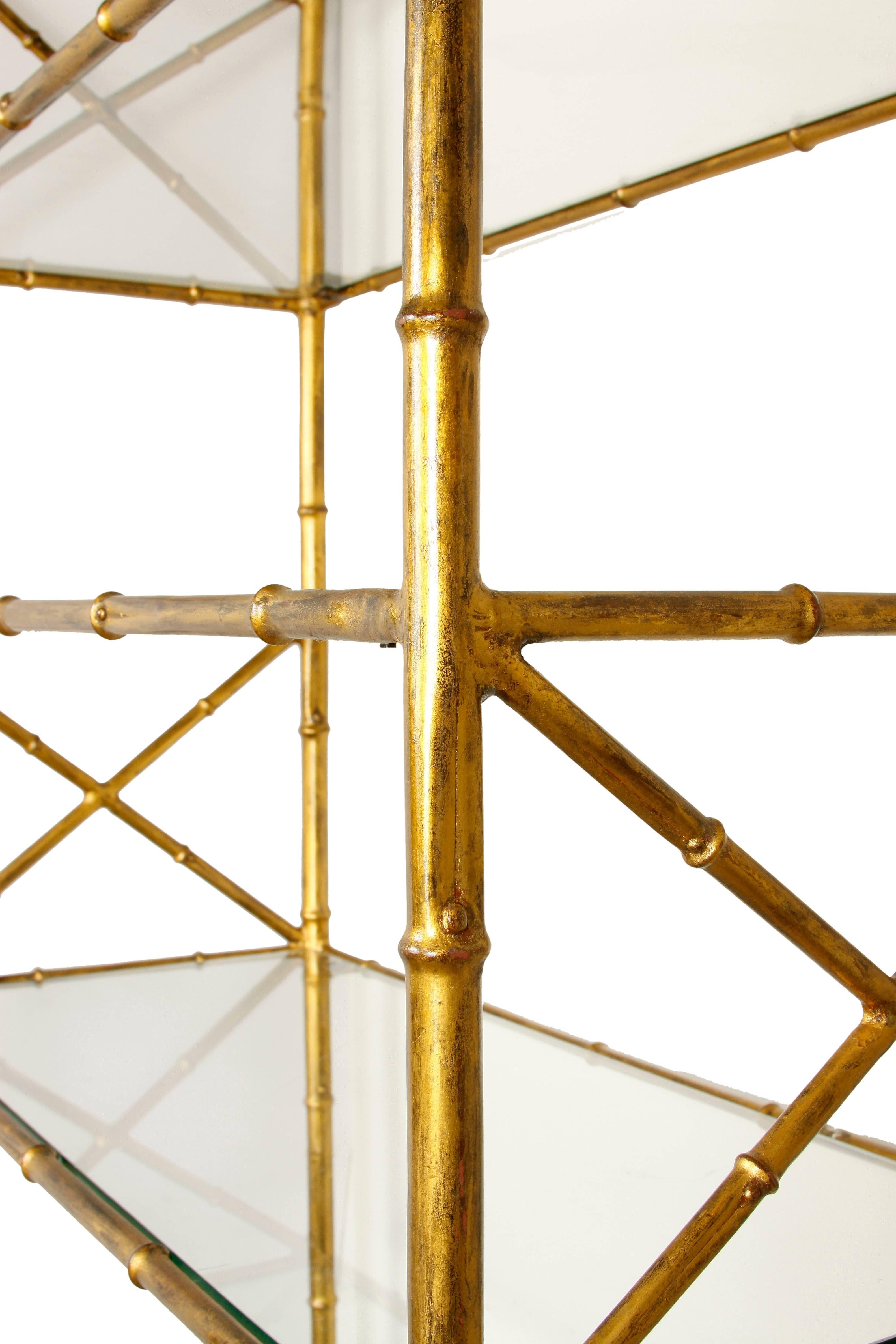 A nice looking and versatile pair of gilt metal faux bamboo étagères with glass shelves. They are in great condition, with lovely detail and x-form design on sides. Perfect for anywhere in the home!

The measurement of the space between each shelf