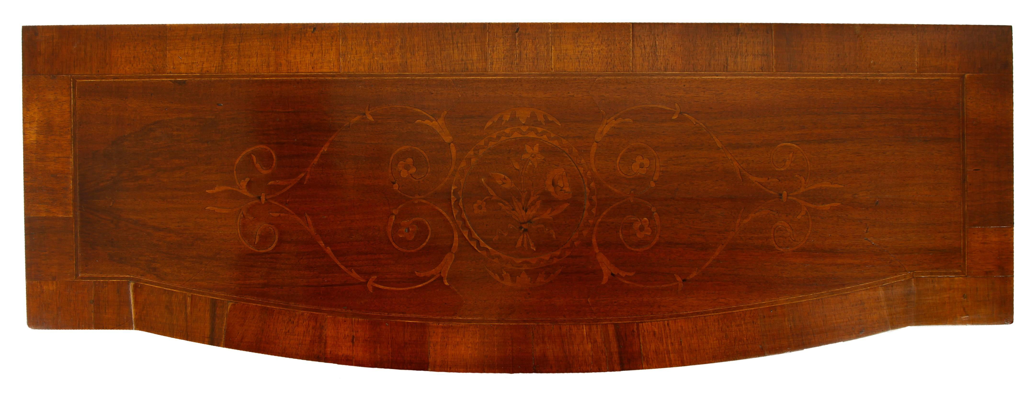 A charming Italian walnut console table with a slightly bowed front and a single drawer. This little gem features a top decorated with a crossbanding and a lovely inlaid design and is raised on squared, tapered legs. Its narrow depth makes this