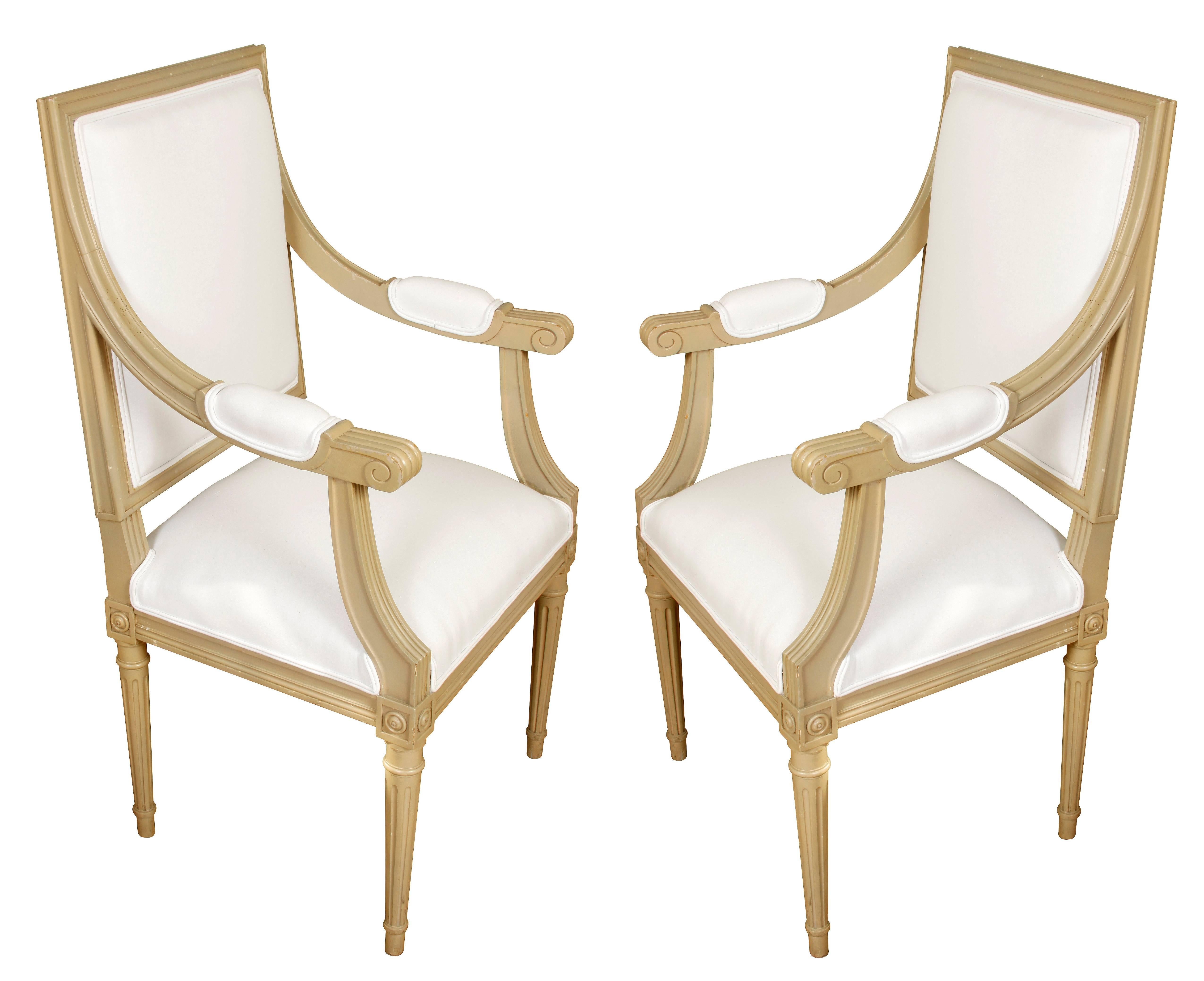 A Set of Ten Louis XVI Style Dining Chairs with a painted finish, including two arm chairs and eight side chairs.  The clean lines of this set, and the understated details give them versatility--they would work in contemporary or traditional