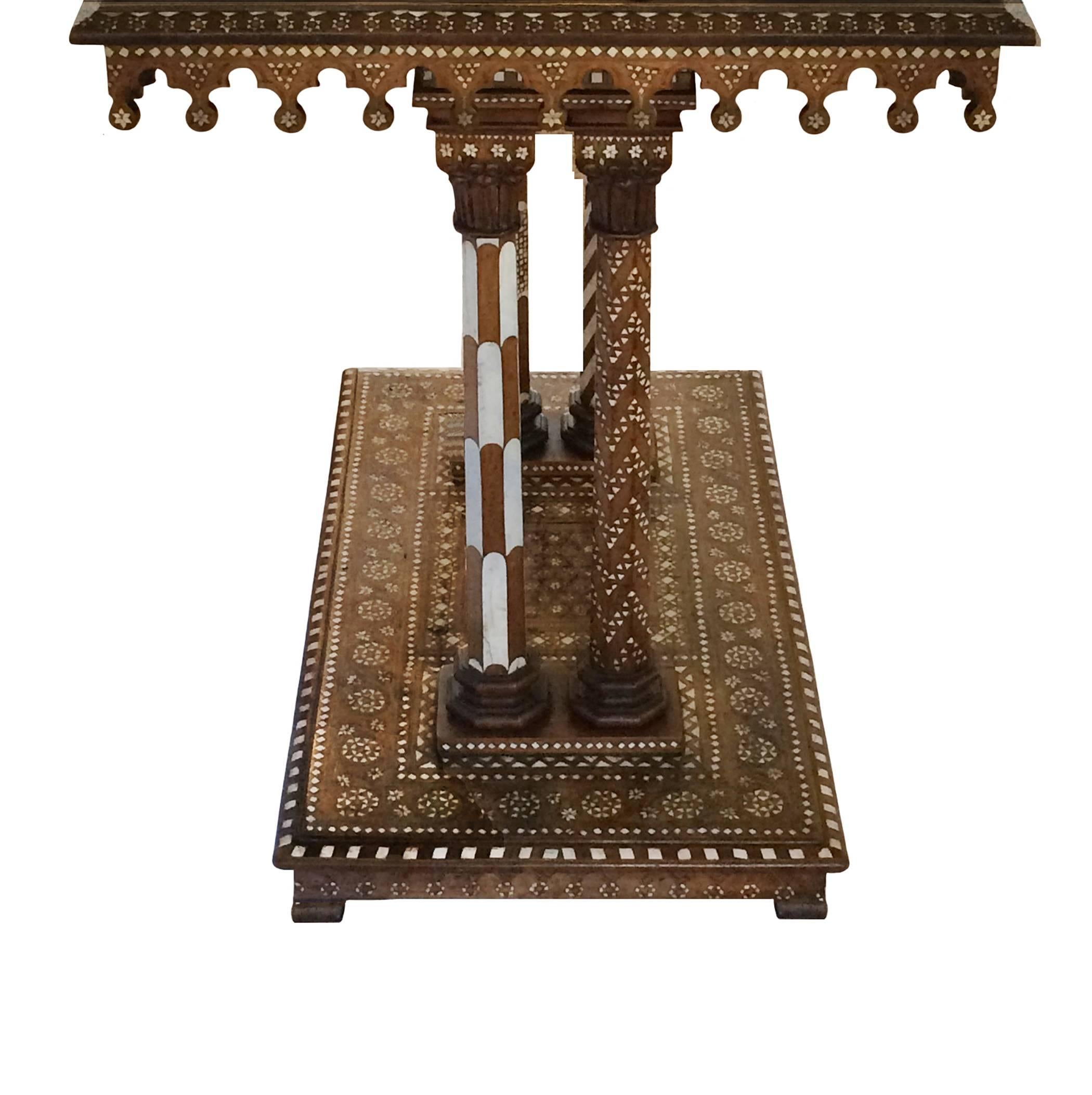 Intricate Italian bone inlay ebonized walnut table in the Moorish style series of fixed tassels around the perimeter supported by four assorted hexagonal columns sitting on a platform base, 19th century.