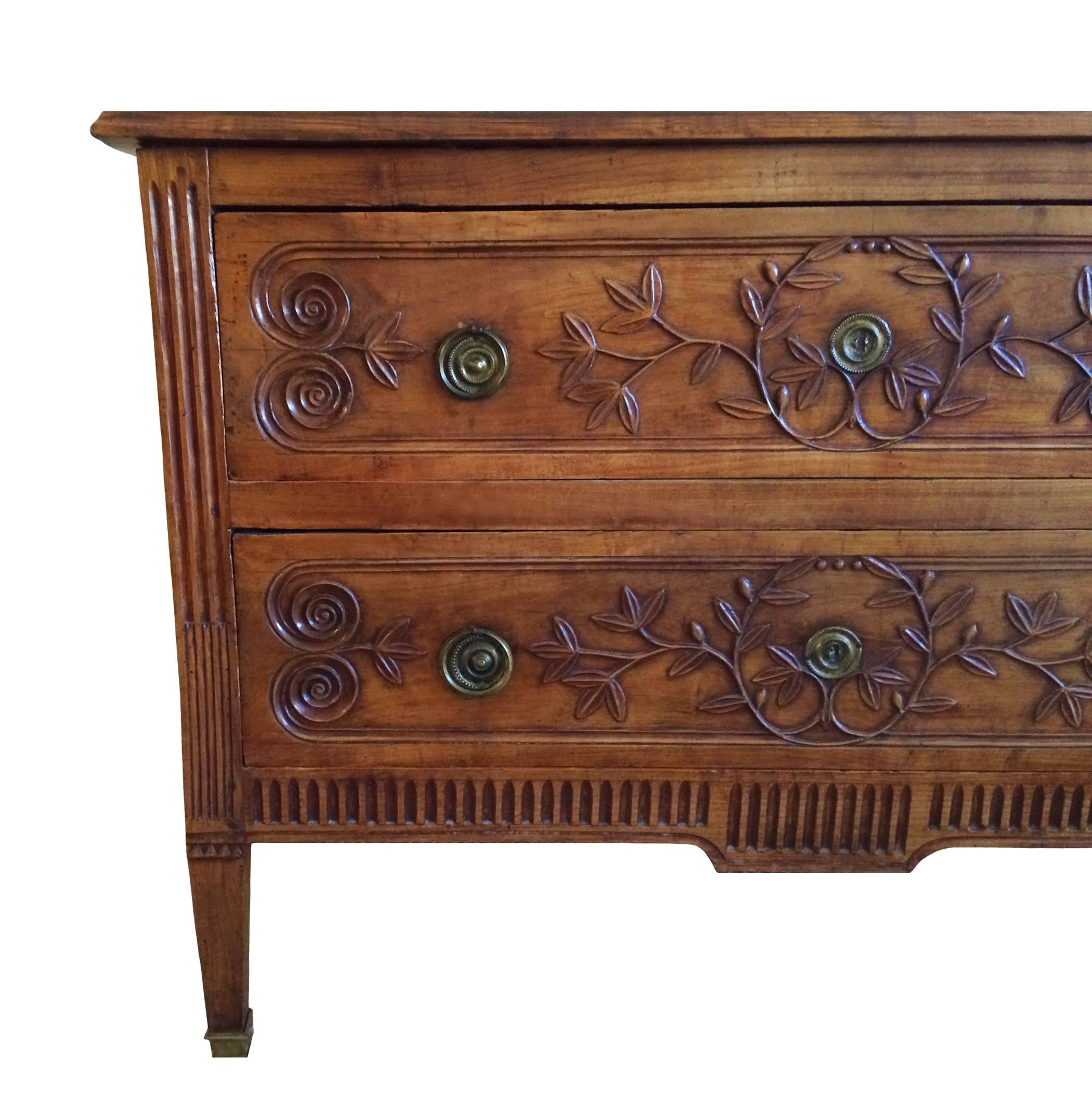 Exceptional Louis XVI walnut commode with classical vine carving, fluted detailing; ormolu hardware; 18th century.