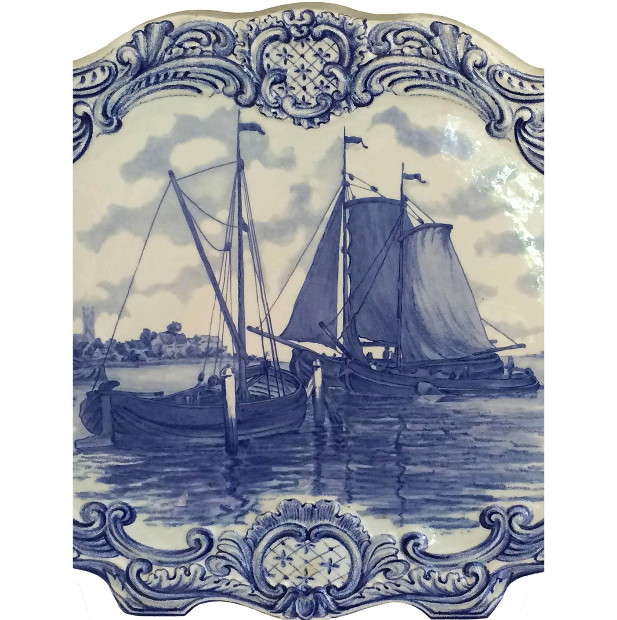 Delft wall plaque with sailing vessels on a serene body of water; undulating raised border; 18th century.