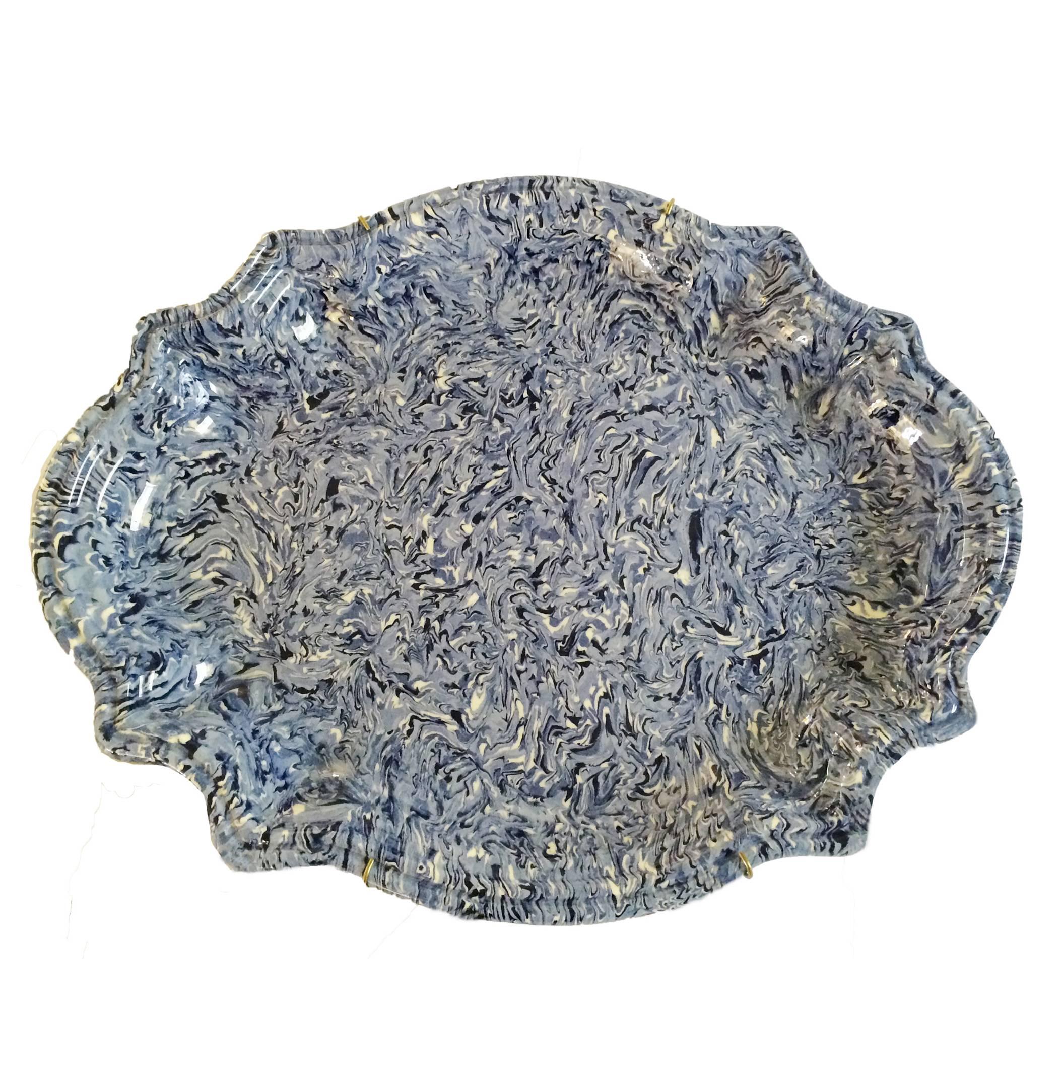 19th century French marbleized oval faience platter from Apt. Mixing a varied range of blues to create a sumptuous pattern with a beautifully scalloped rim.