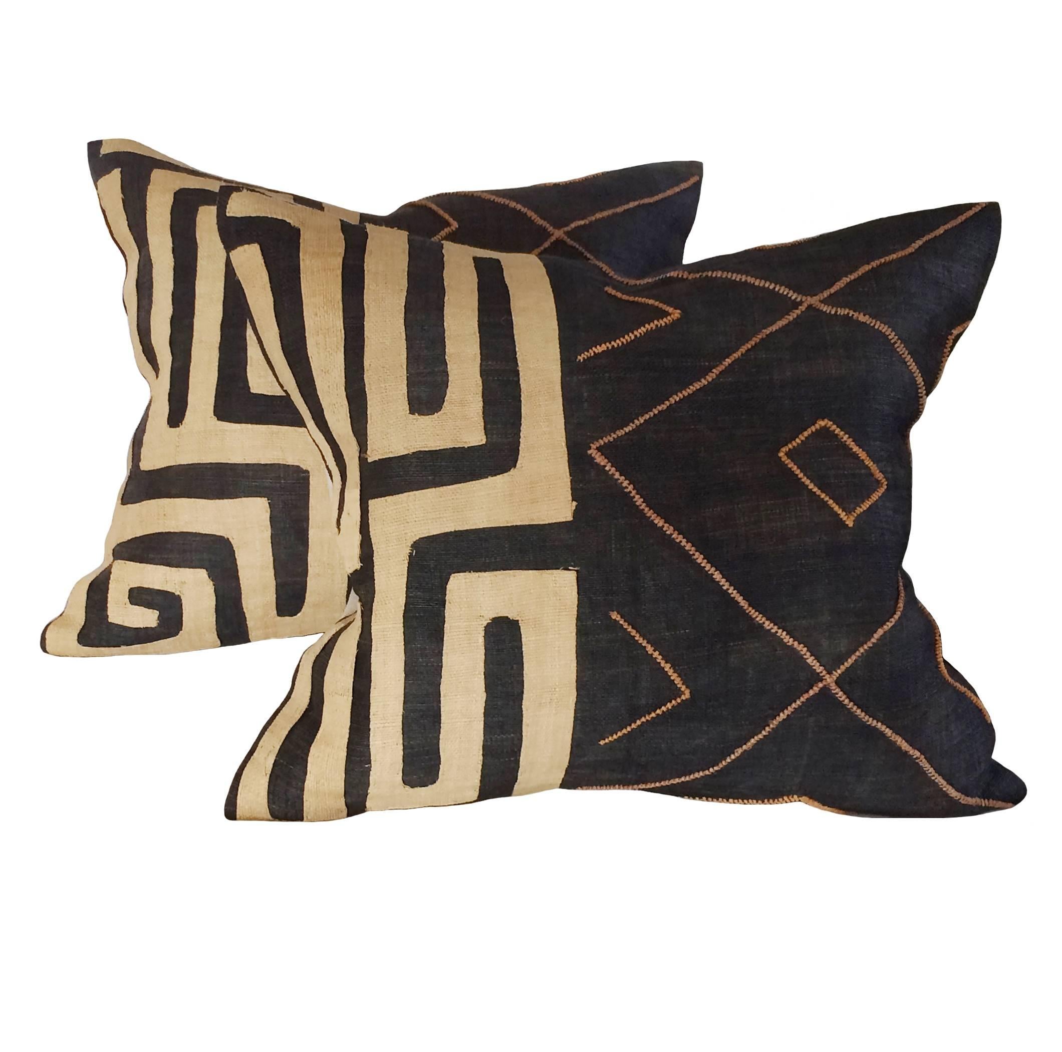 A pair of vintage Kuba cloth down pillows; pieced and beaded raffia; 19th century; African Congo.