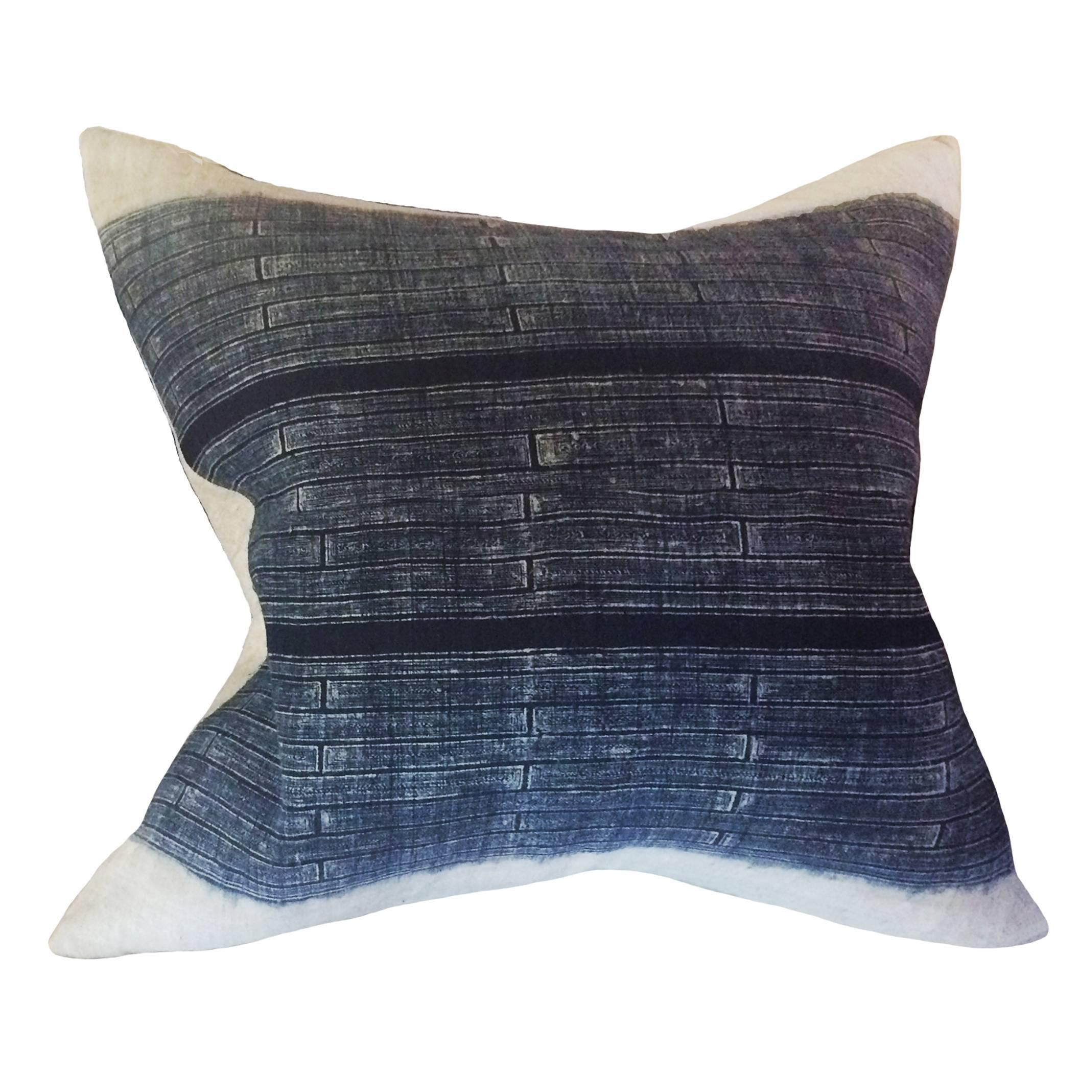 Japanese Indigo Batik down pillow; variegated blue stripes, bleeding into ivory borders; 19th Century.