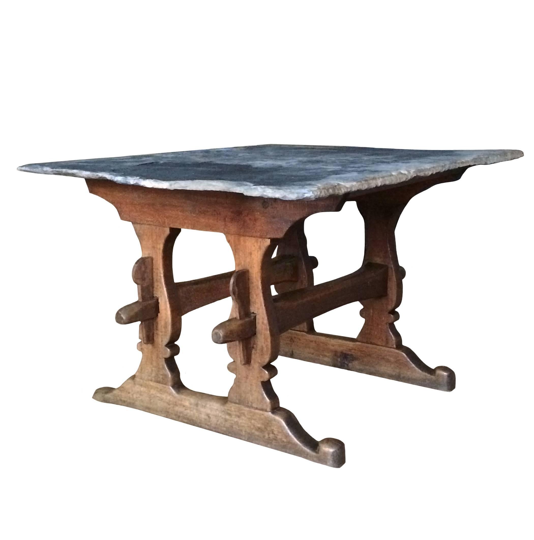 French beechwood trestle table with original slate top, 18th century.
       