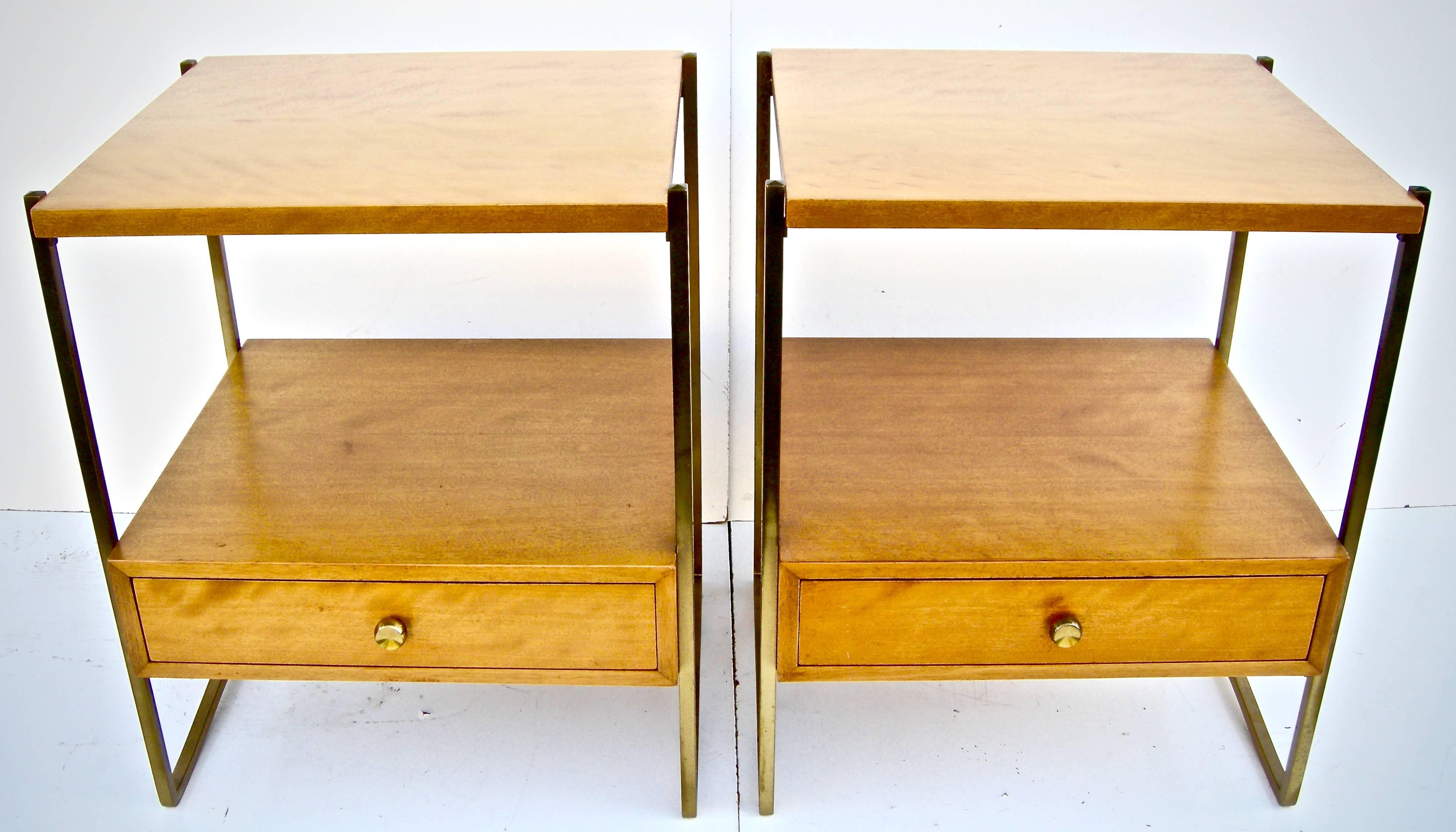 Striking pair of vintage and seldom seen, modernist-style chests by the iconic, Kittinger Furniture Company. Beautiful, light wood, flame-grained veneer finishes with bronze-like, brass supports. Stylish curved-raised stretchers add pleasing