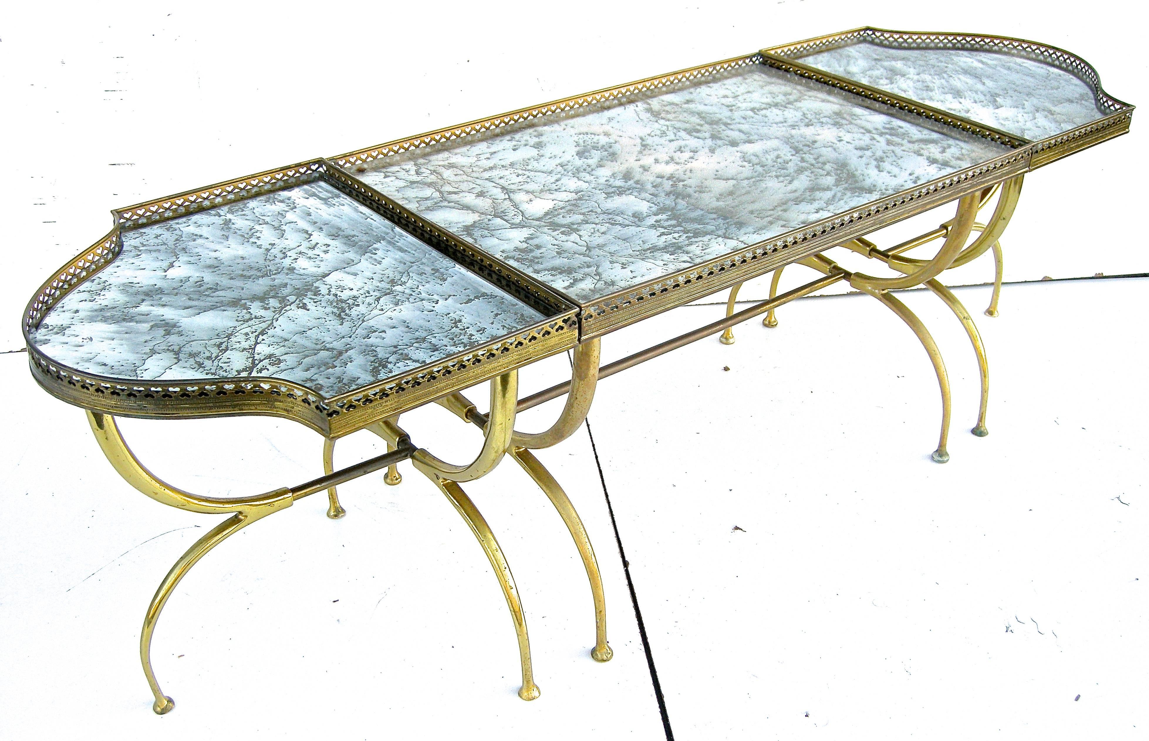 Elegant, vintage Italian, mirrored and brass coffee table. Sophisticated, detachable, trio of separate tables forming stylish, individual shapes and forms. Having detailed, perforated galleries atop curving sinewy bases/legs. Warm oxidized, aged