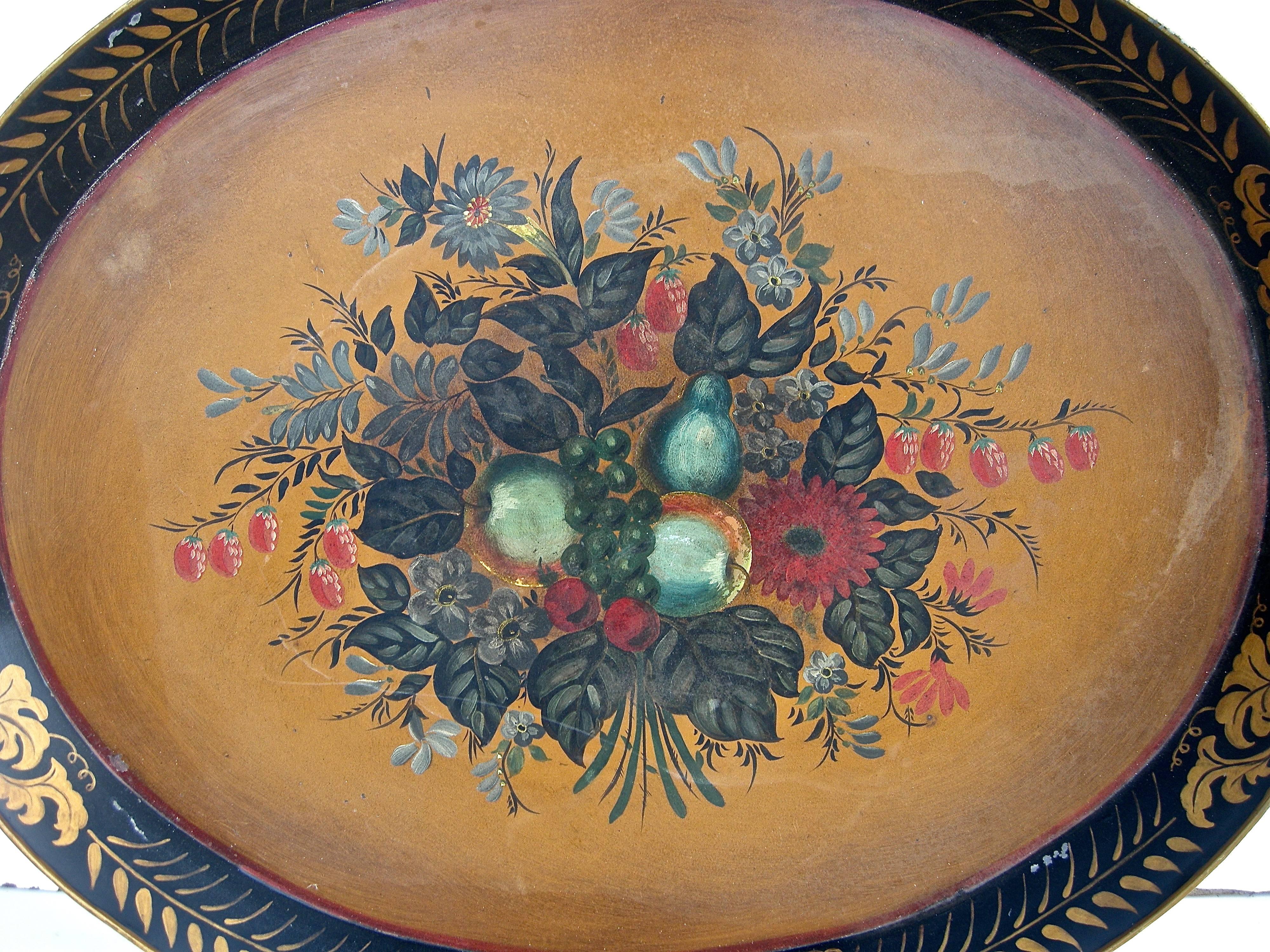 Vibrant, early 20th century, tole serving tray. Bold, graphic and colorful fruit and floral motif with classical, perforated gilt accented rim and border.