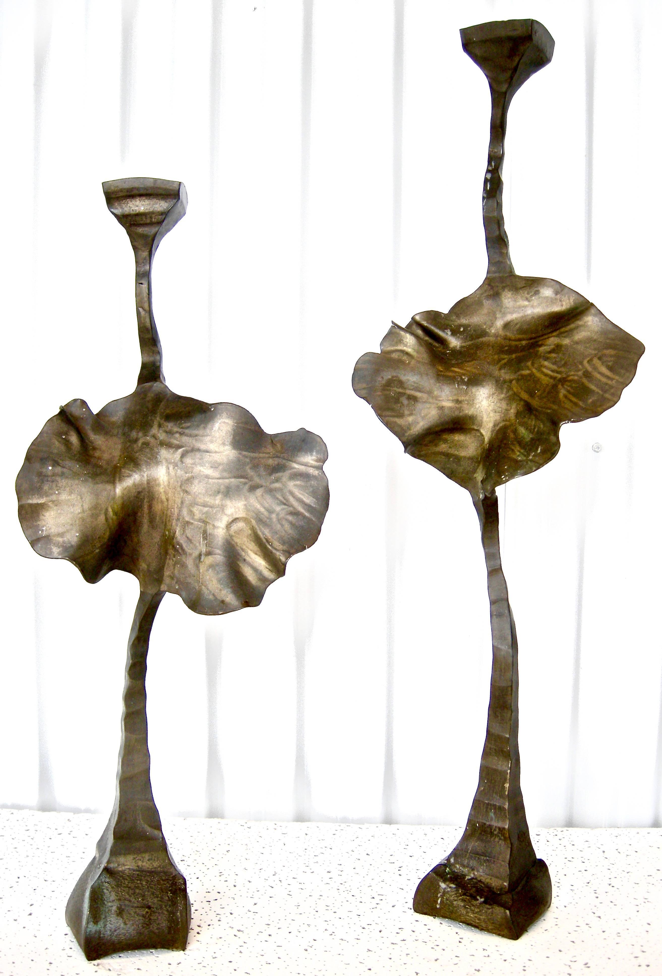 Striking pair of vintage, bronze, candleholders having abstract lotus leaf motifs. Artisan hand cast and designed in  semi-brutalist style, shape and forms. Warm time-worn surface and patinas. Initial signed. 1989 dated. Aesthetic and visually