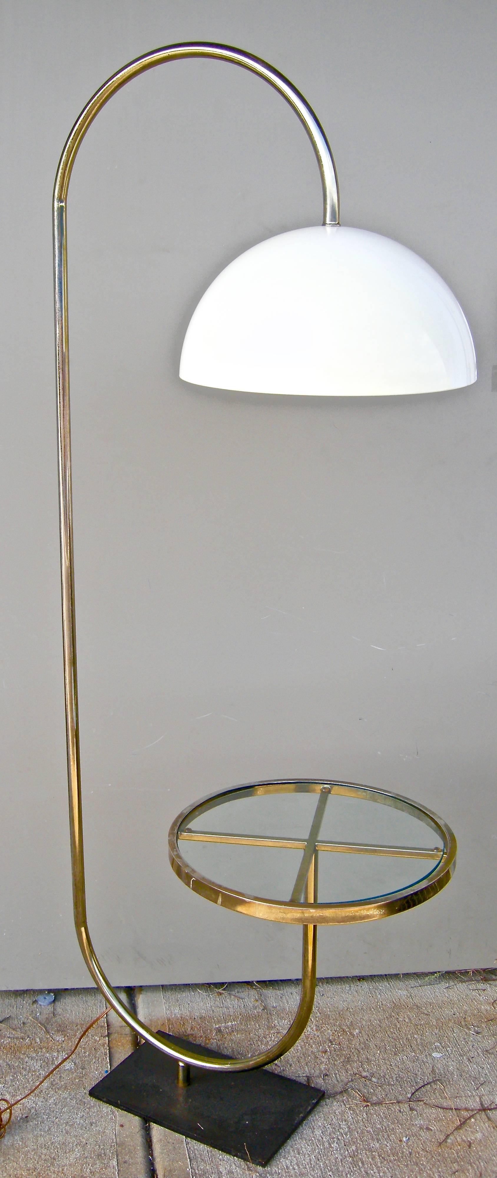 Fantastic vintage, Italian designed, brass floor light in a a graphic tubular shape and form. Having a rotating attached table top with molded plastic dome shade. A sculptural delight.