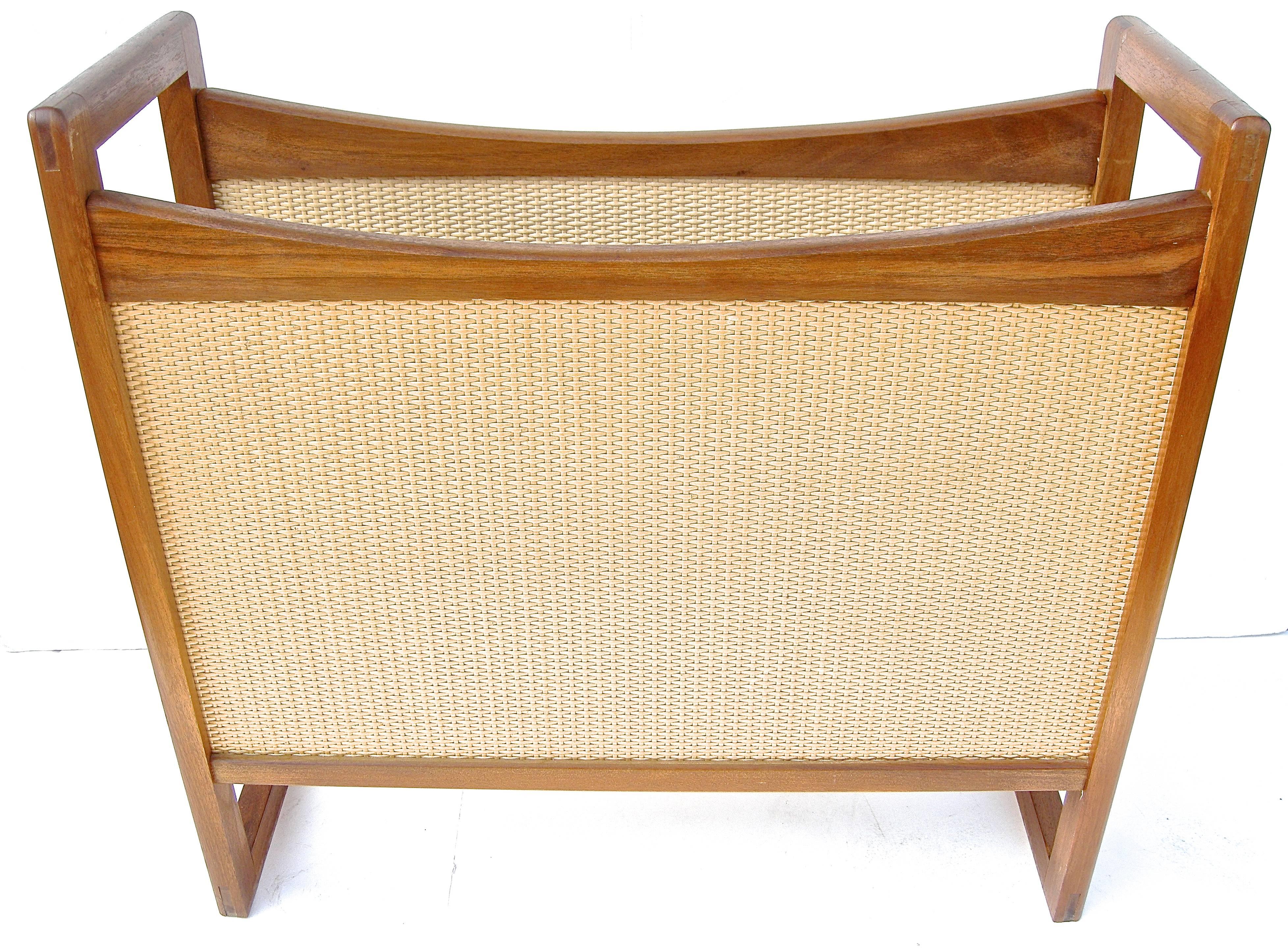 Classy, vintage, Danish modern periodicals holder. Sculptural wooden construction with eye-catching, tightly woven wicker side panels.