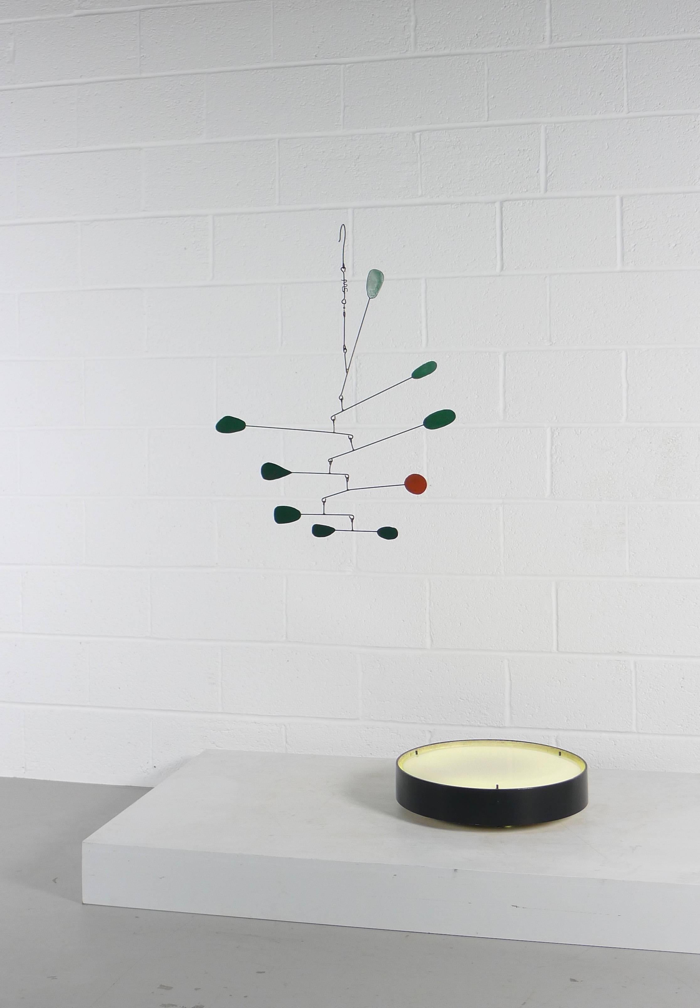 William Magaw hanging mobile, USA , 1960s . Metal structure terminating in eight green and one orange organic shaped weights.

Beautifully balanced, signed to the upper stem MS for Magaw Studio.