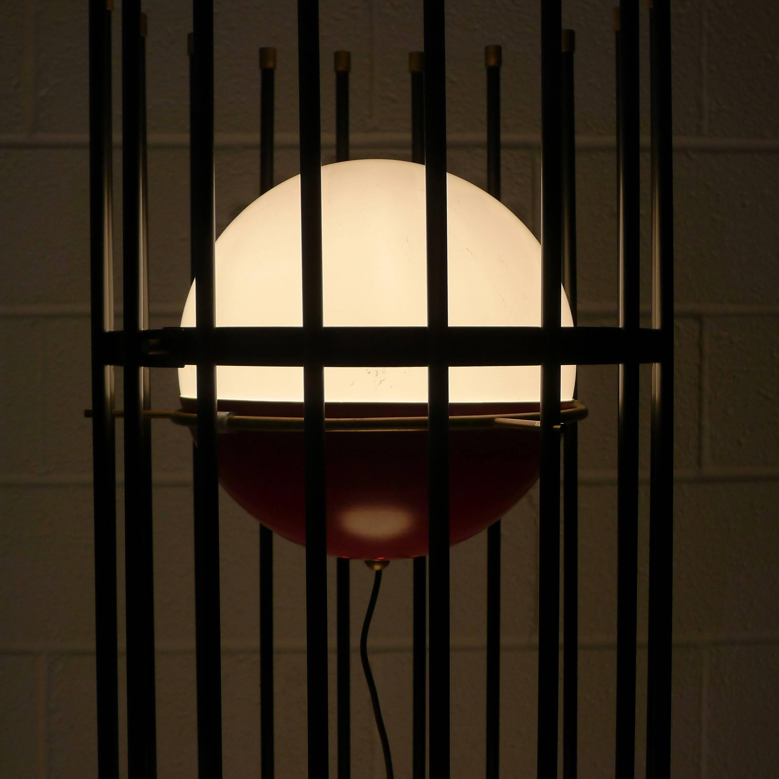 Angelo Brotto for Esperia, Italy, circa 1960. 

Black lacquered metal cage housing three illuminated globes of red metal and frosted glass.