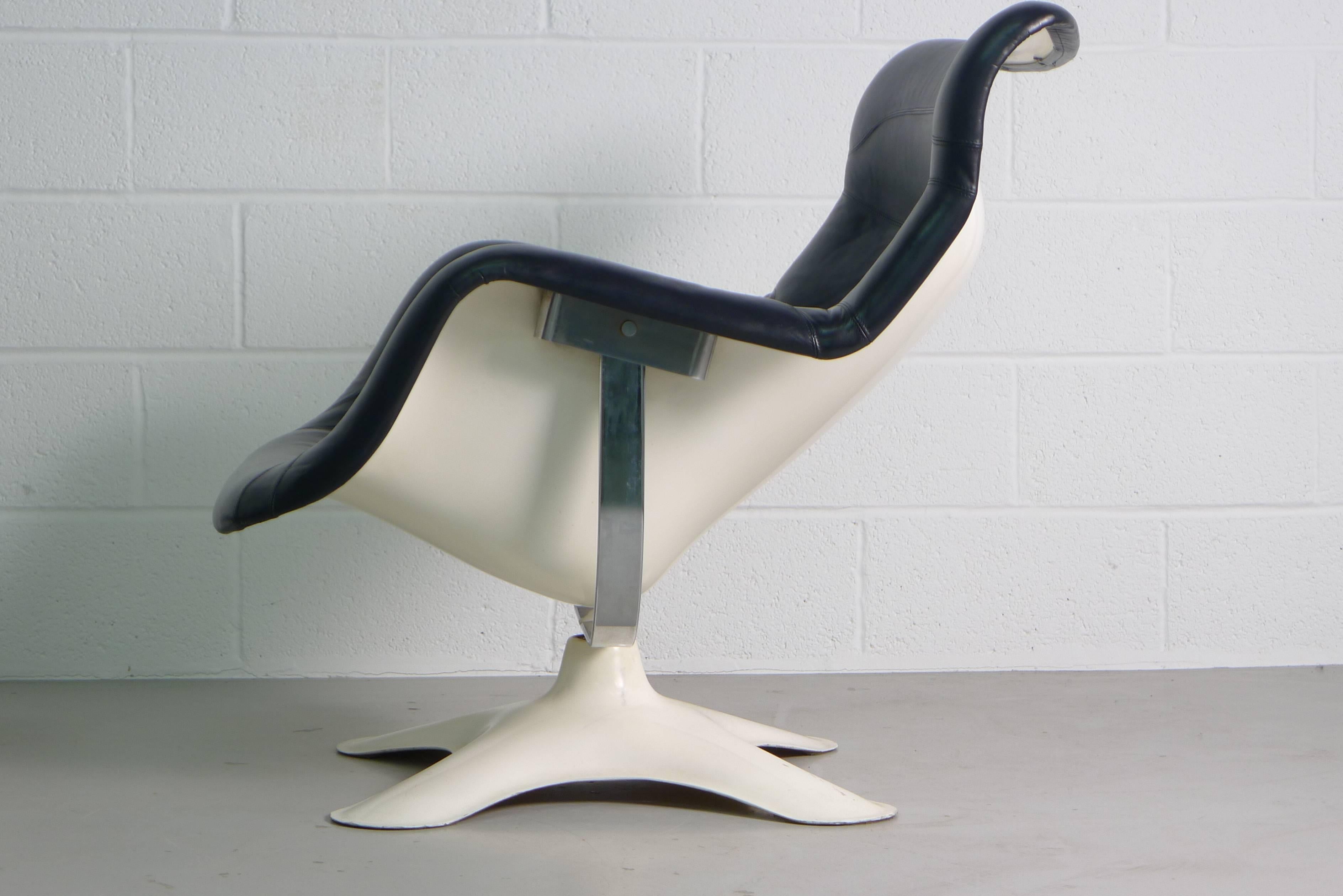 Yrjo Kukkapuro Karuselli chair for Haimi, Finland, 1964.
Chair and stool in beautifully patinated black leather over white fibreglass shell, chair reclines and swivels. 
Both pieces retain their original Haimi labels.

Measurements of ottoman 38