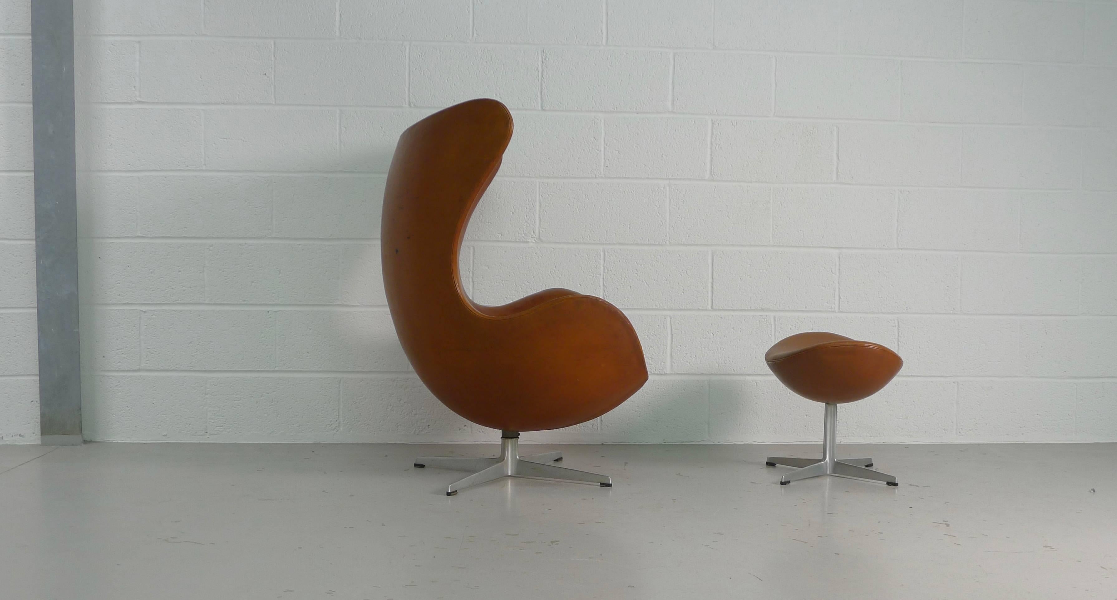 Arne Jacobsen for Fritz Hansen, Denmark, 1958. This example was produced in December, 1966 and both chair and ottoman carry matching dated labels. Gorgeous original brown leather, aluminium profiled base.
The leather on this chair is over 50 years