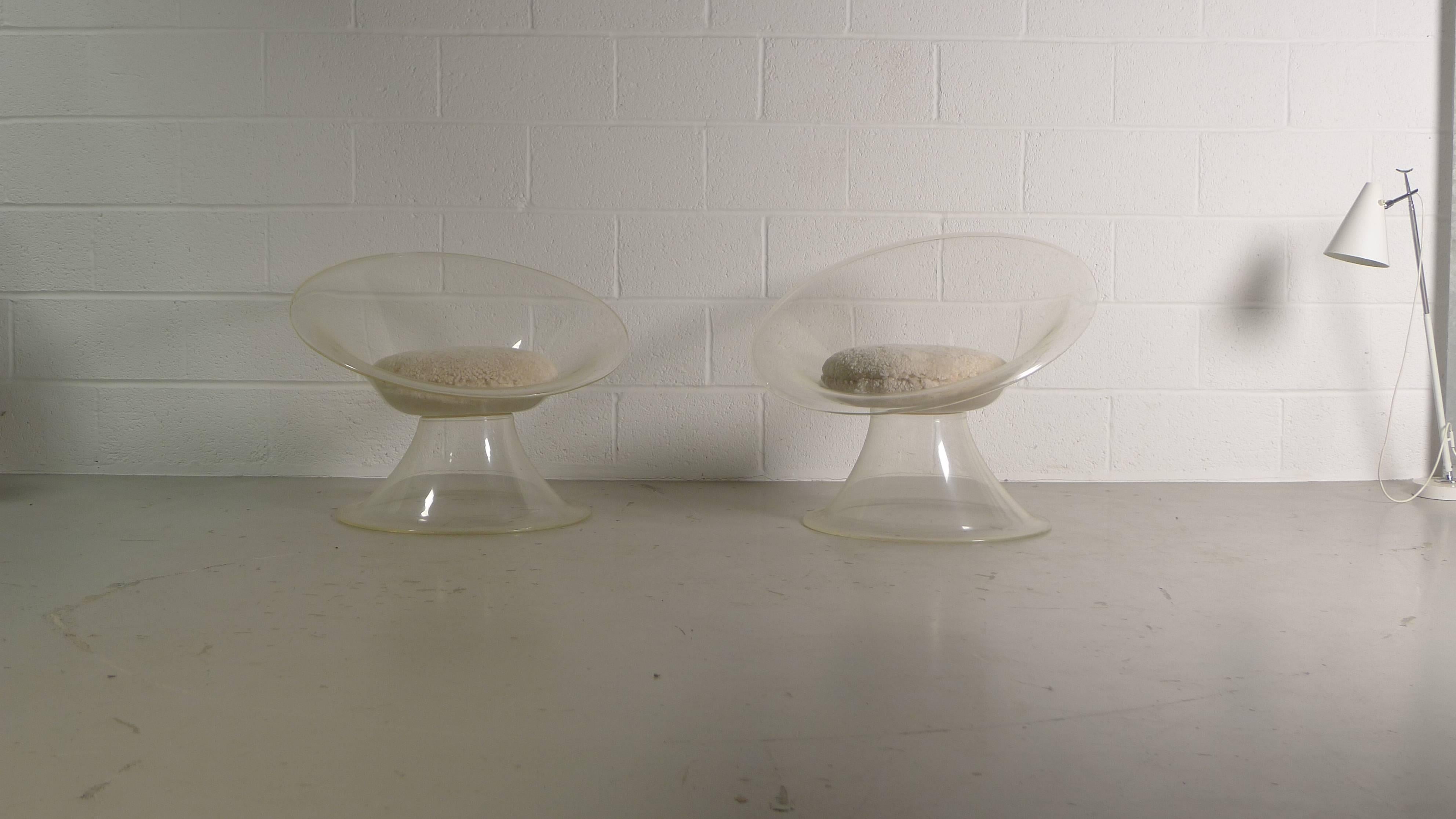 Erwine and Estelle Laverne, circa 1960, a pair of Buttercup chairs in clear Lucite with sheepskin seat cushions.

Some light age appropriate scratches to Lucite. 
Priced for the pair.