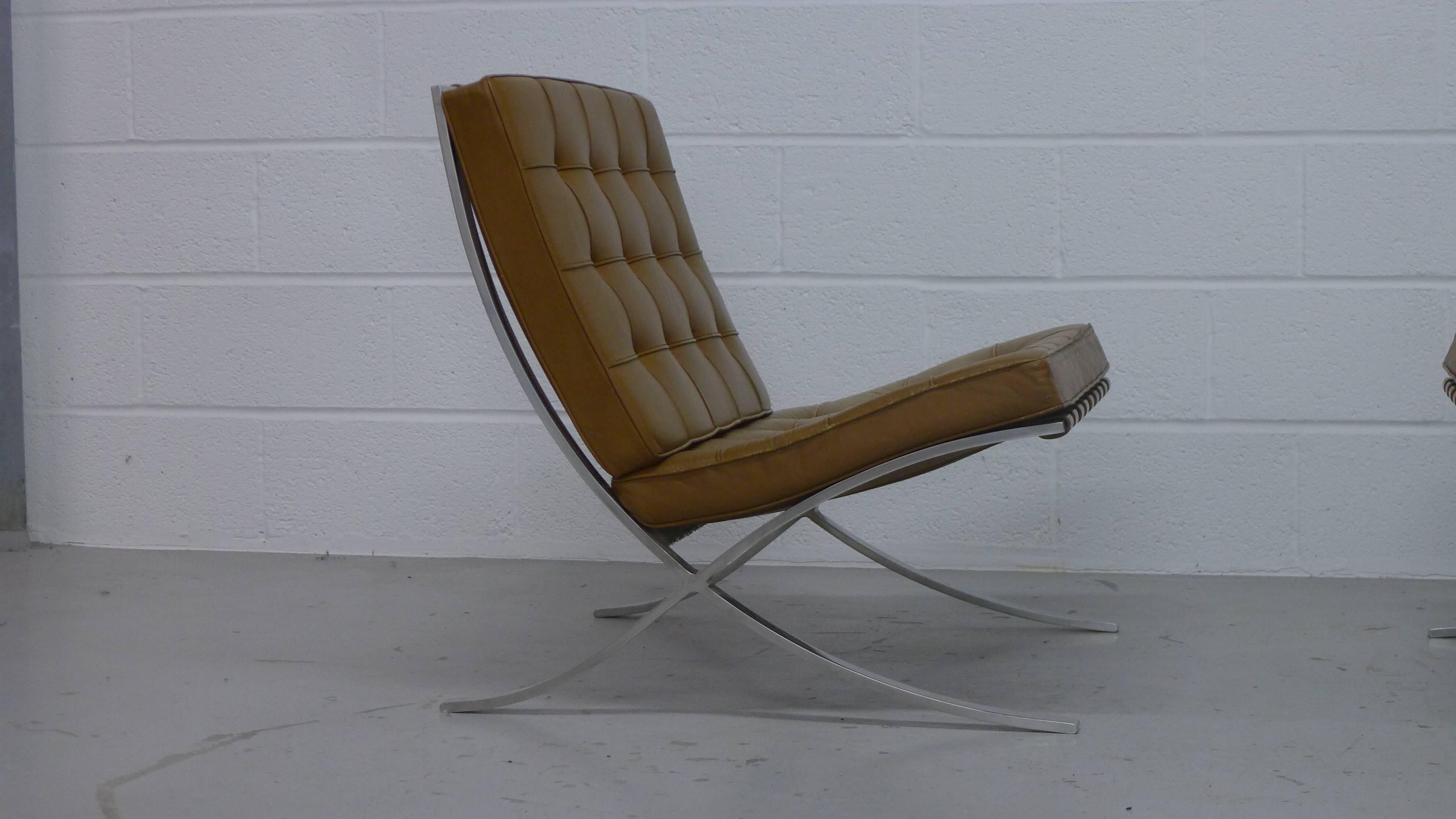 Ludwig Mies Van Der Rohe, for Knoll International, USA. Pair of vintage 1960s Barcelona chairs with original tan leather cushions, pressed steel frames and labels to underside. 
Some wear to seat cushions but no holes, rips or tears. 
Priced for