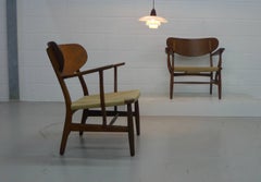 Hans Wegner for Carl Hansen, Denmark, Pair of CH22 Armchairs, 1950s