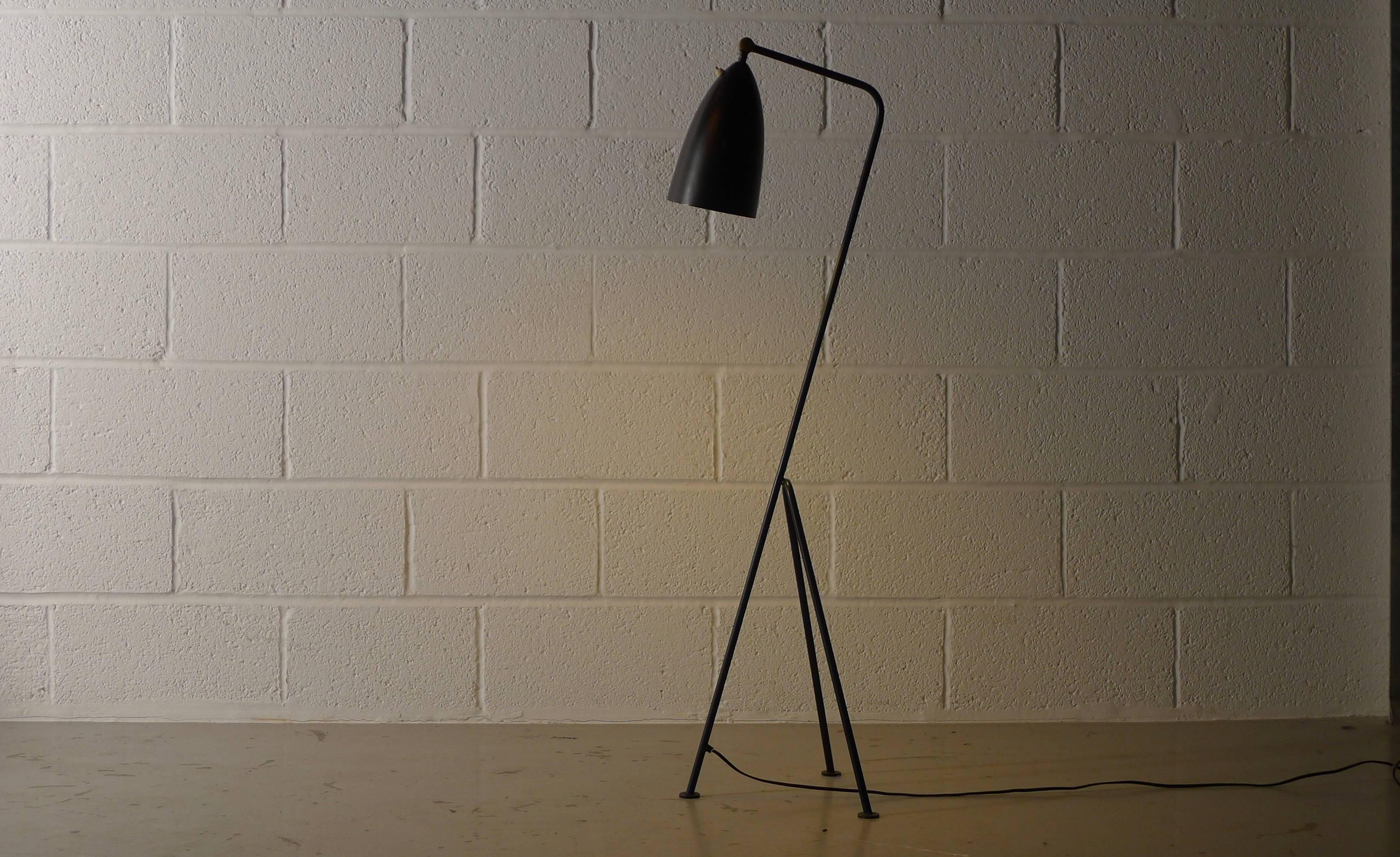 Greta Magnusson-Grossman for Bergboms, Malmo, Sweden. Model G-33 floor lamp with adjustable conical shade on tripod base, black enameled steel and brass fittings.

Good original condition with label.