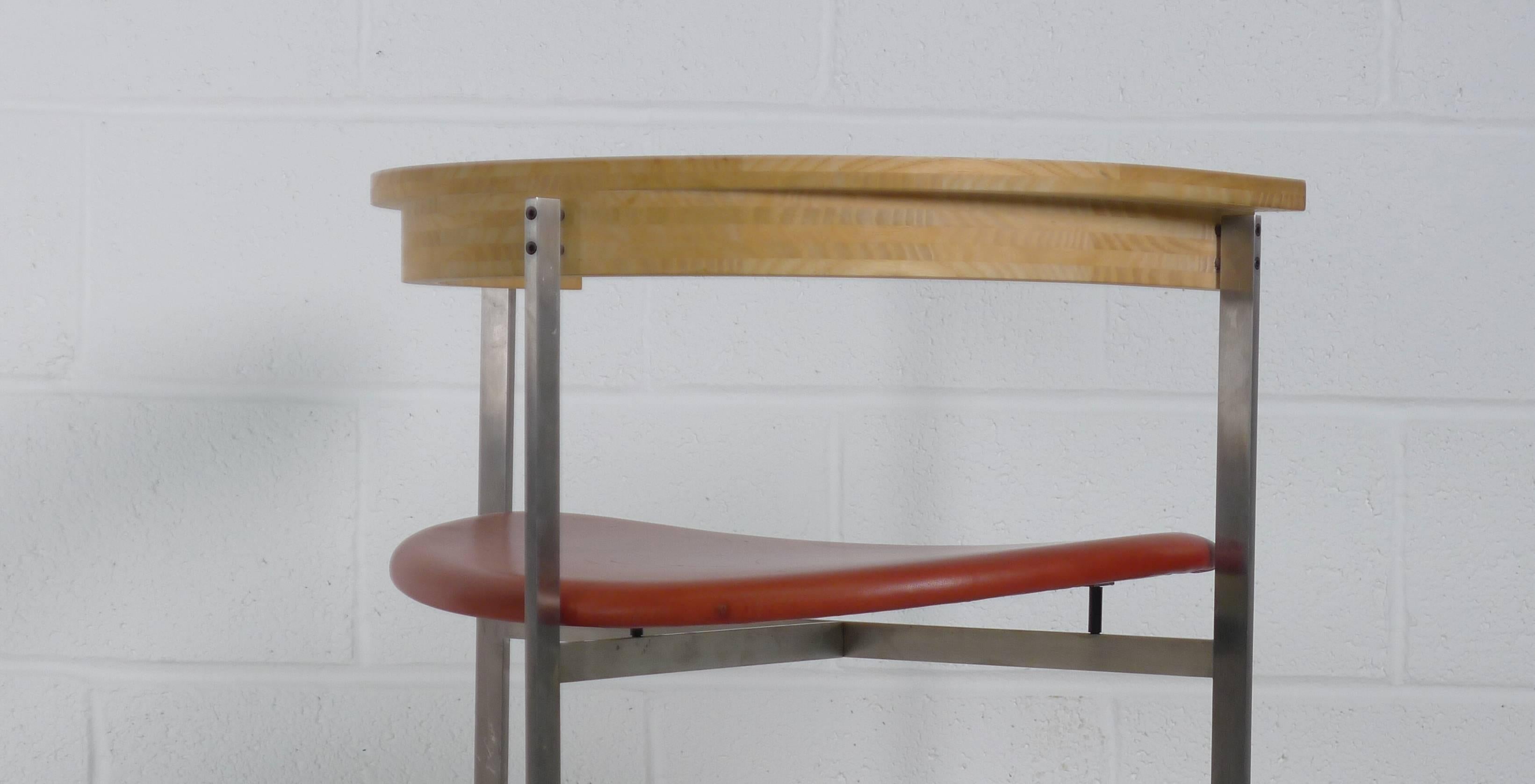 Poul Kjærholm designed, 1957 for E. Kold Christensen, Denmark. Brushed Steel framework supporting red/brown leather seat and sculptural curved wood backrest. This example manufactured by Kjaerholm Designs circa 1990 and no longer in production,