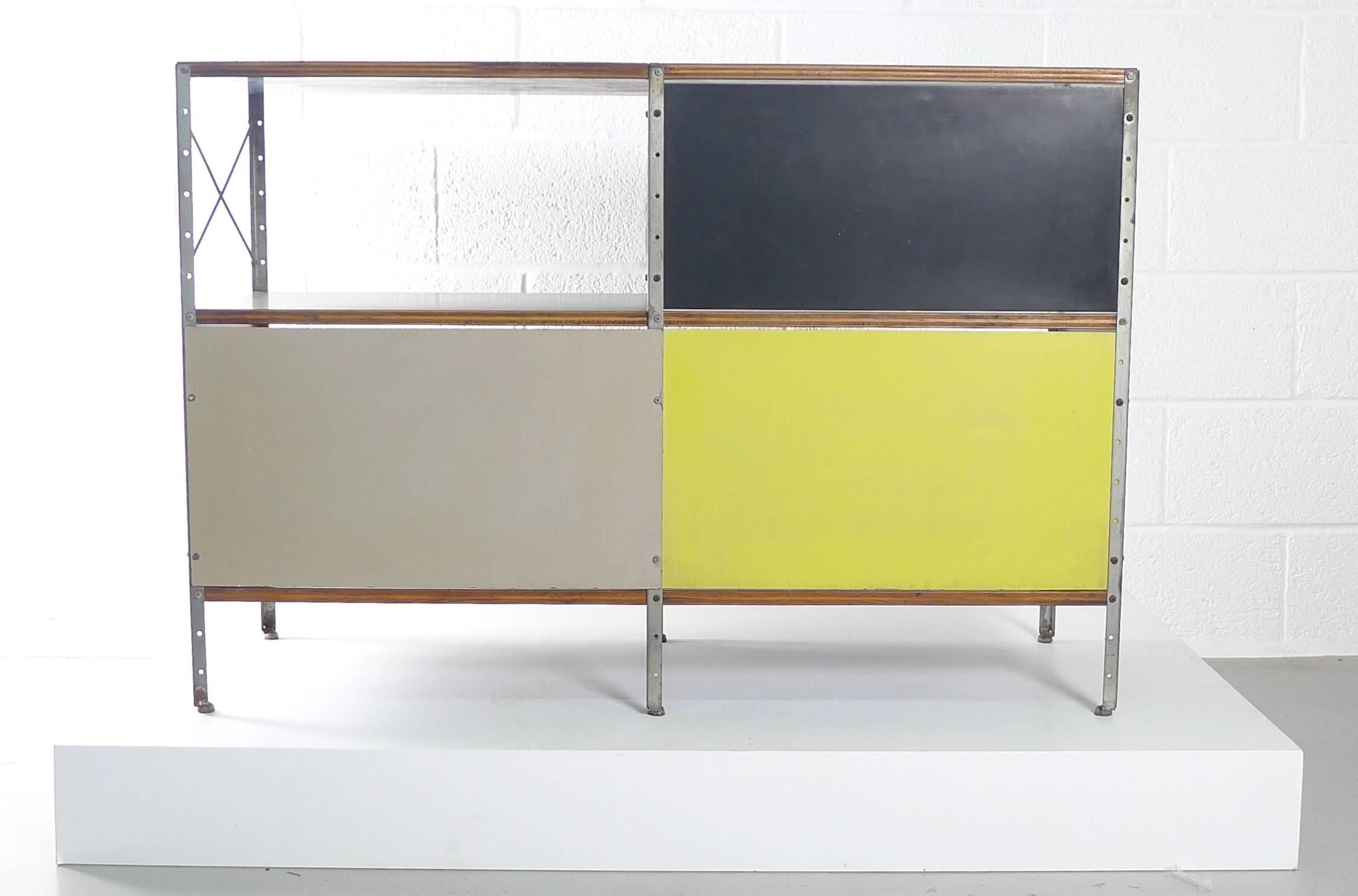Charles & Ray Eames for Herman Miller USA, ESU 200 - C, first series circa 1950 with black laminate shelves and top, Masonite back panels in a stunning combination of black, grey and yellow. 

This unit is a nice original early example in original
