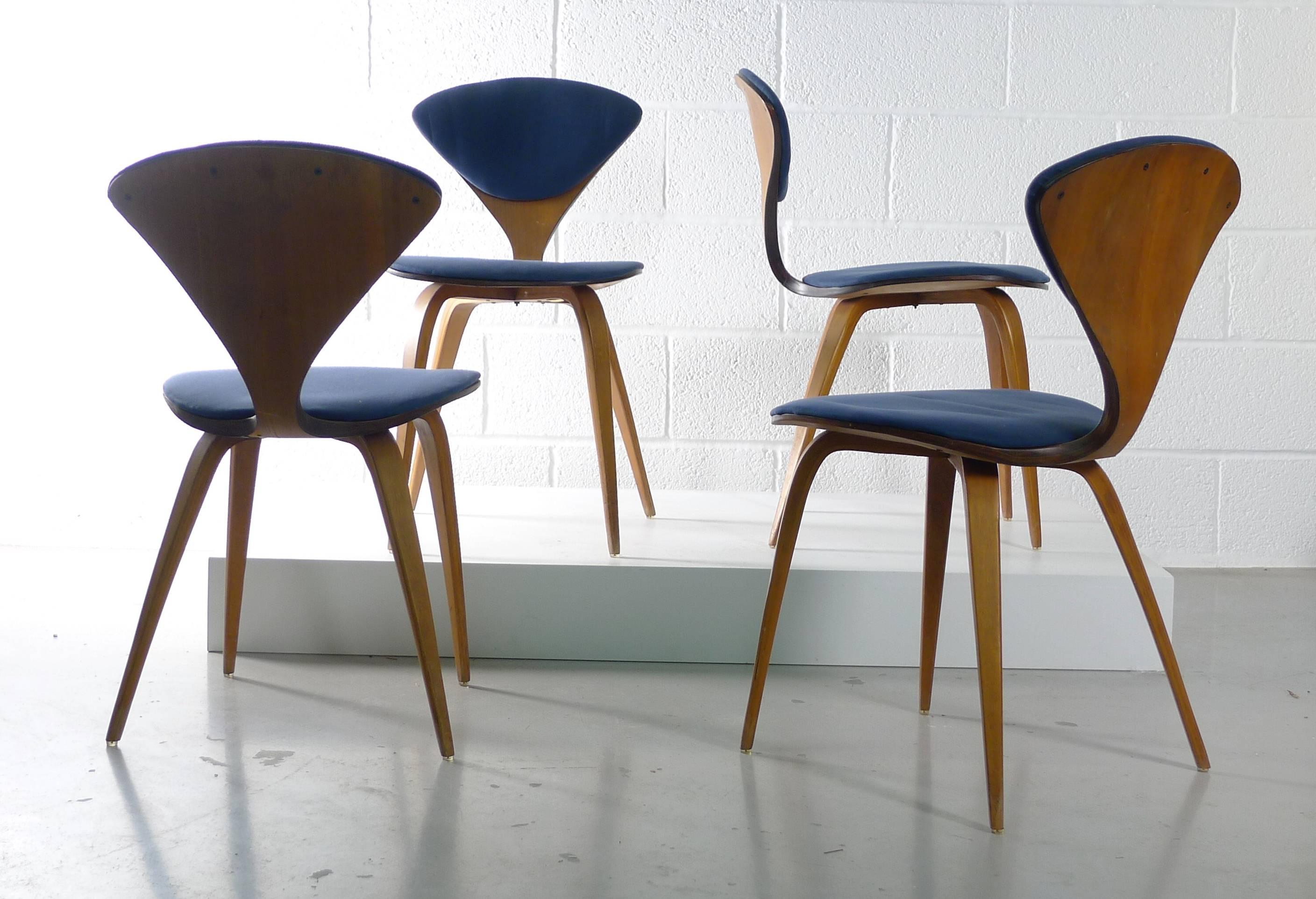 Norman Cherner for Plycraft , Mass , USA. Designed circa 1957 these examples are from the early to mid-1960s. Moulded plywood framework with blue upholstered seats and backs .
Each chair retains its original foot glides and each has a full Plycraft