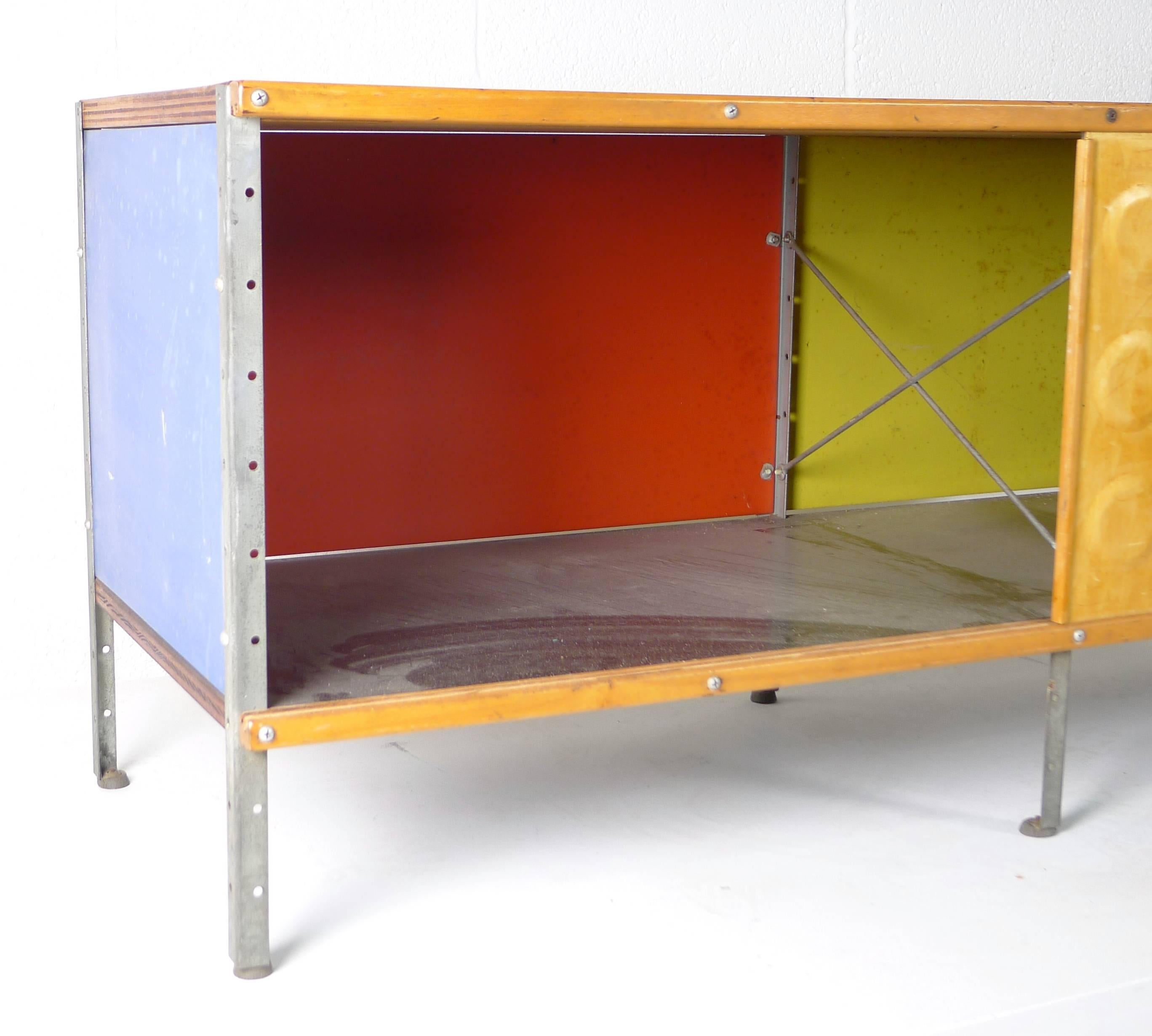 Charles and Ray Eames for Herman Miller, USA, circa 1950. A first series ESU 110-c. Zinc plated framework and Masonite panels with plywood top.
Dimple doors look to be old but may not be original to the piece.
Fine vintage condition, doors slide